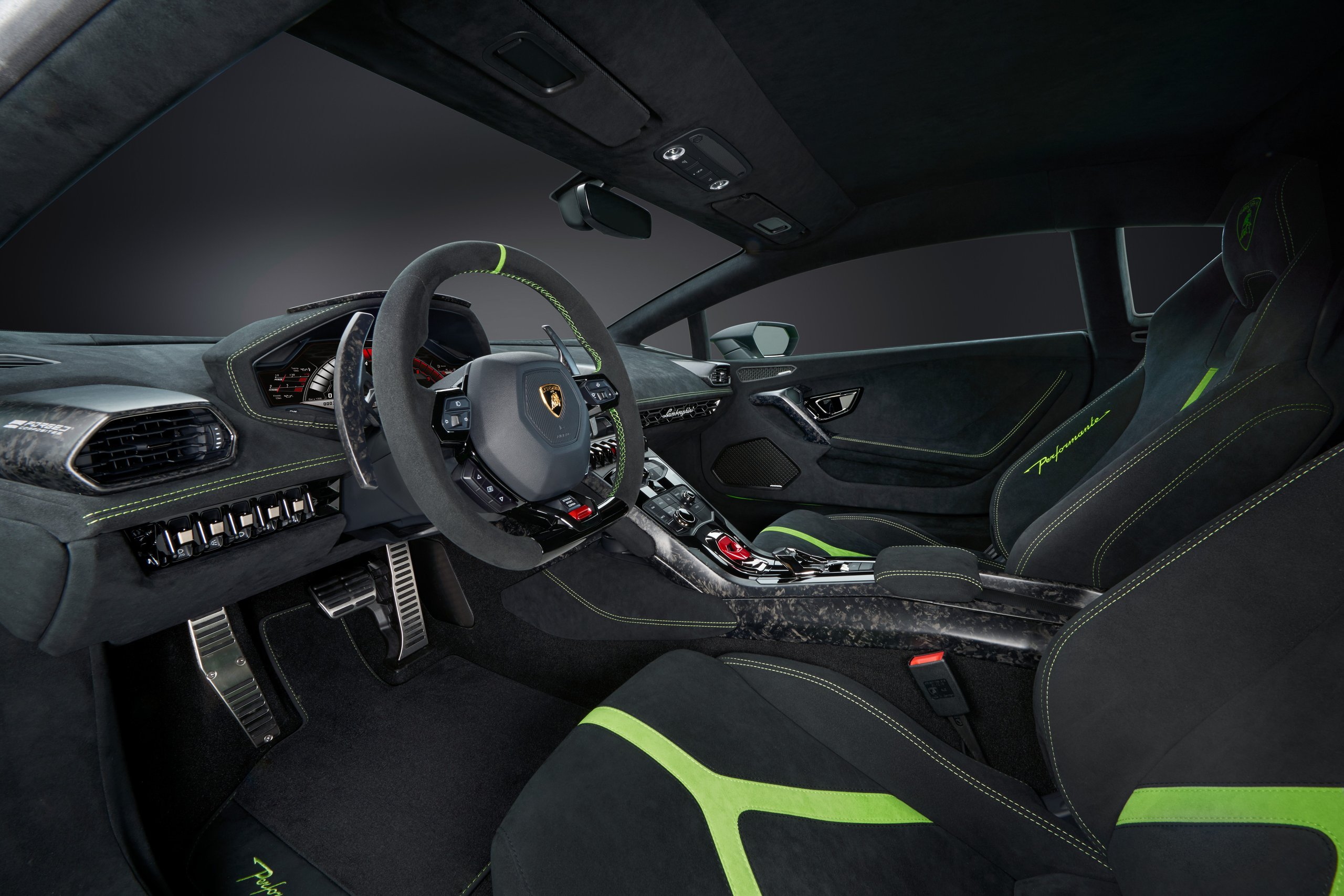 How The Huracán Performante Used Invisible Aerodynamics To Beat A 887-Hp Hybrid Around The Nürburgring 9 Huracán performante interior with black alcantara, green accent stitching, forged composite trim, and digital instrument cluster