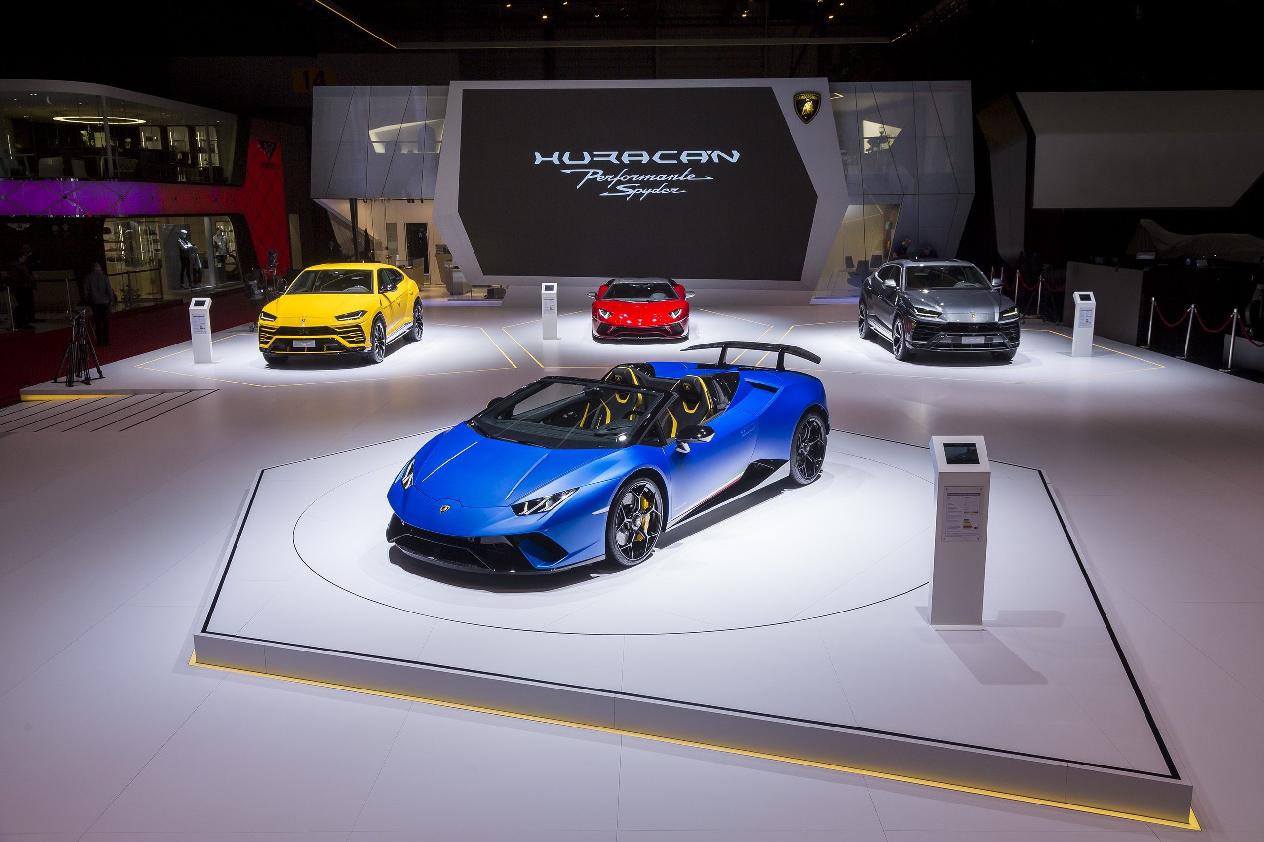 How Lamborghini Kept The Performante Spyder From Being A Compromise 3 Blue lamborghini huracán performante spyder on display at geneva auto show with urus and other models in background