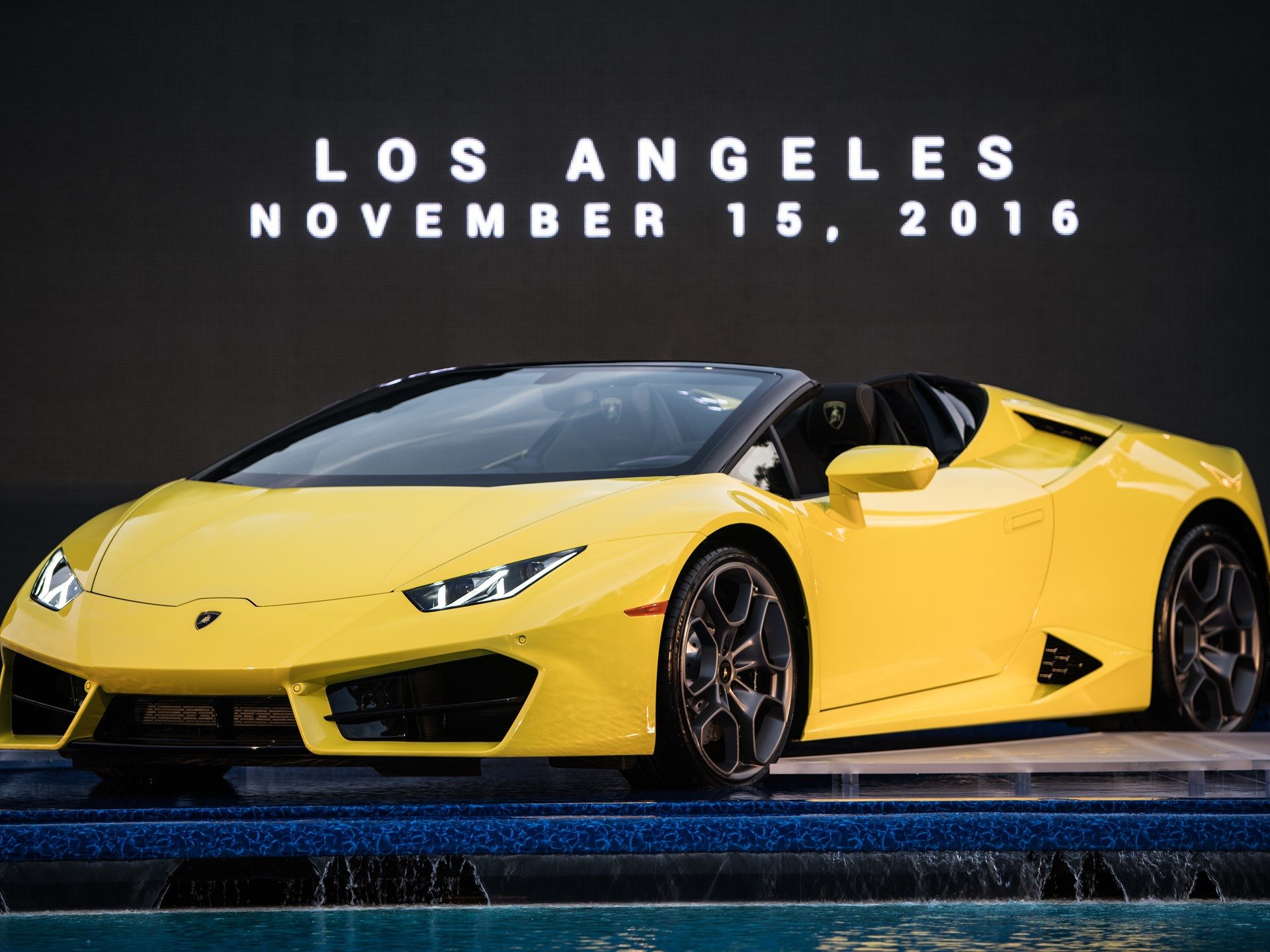 Yellow Lamborghini Huracán RWD Spyder displayed with its soft top down at the Los Angeles Auto Show in November 2016
