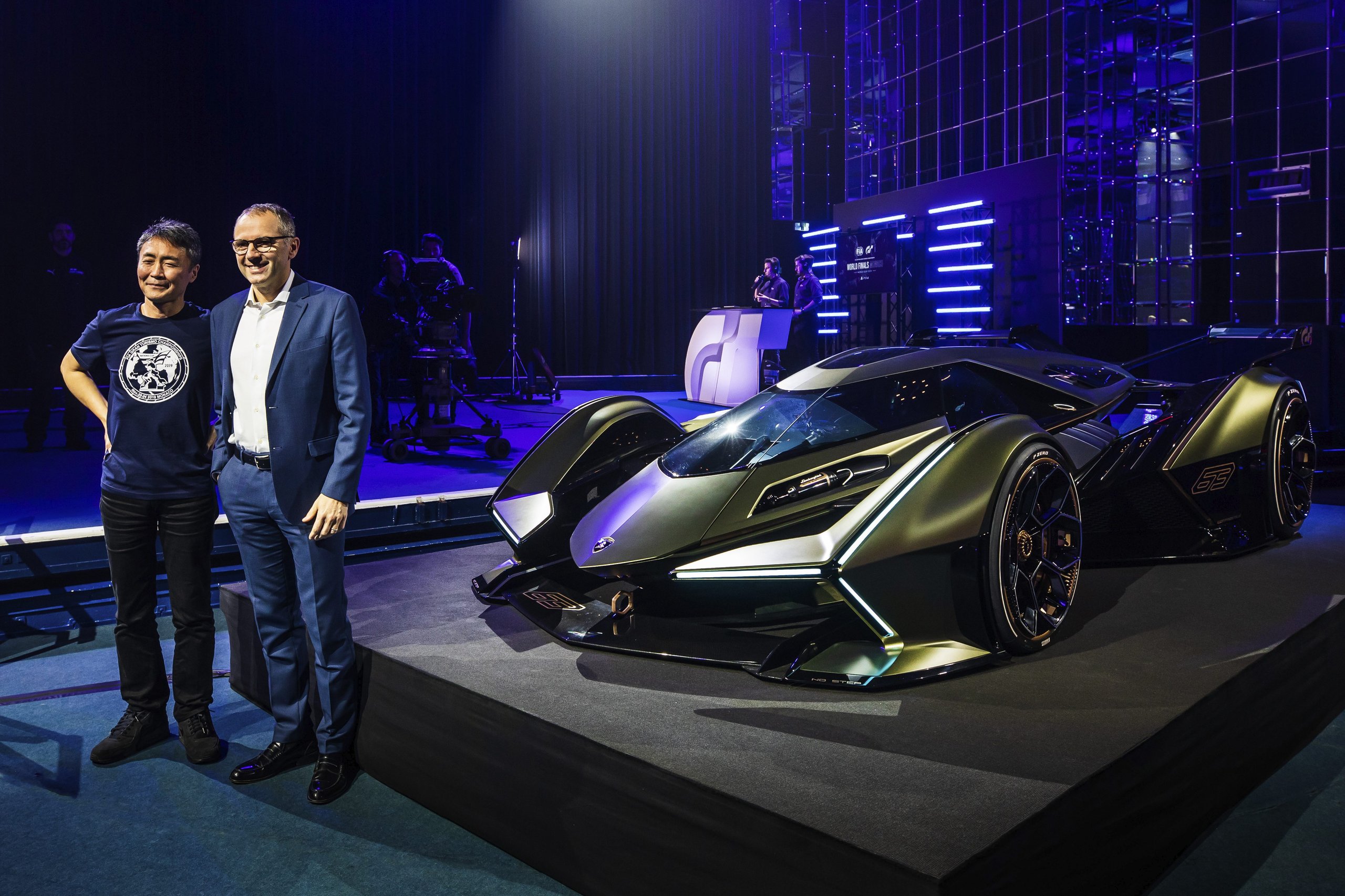 Lamborghini'S V12 Vision Gran Turismo: A Digital Fantasy Built To Recruit The Next Generation 3 Two men standing next to the green lamborghini v12 vision gran turismo concept car on stage at the monte carlo unveiling event