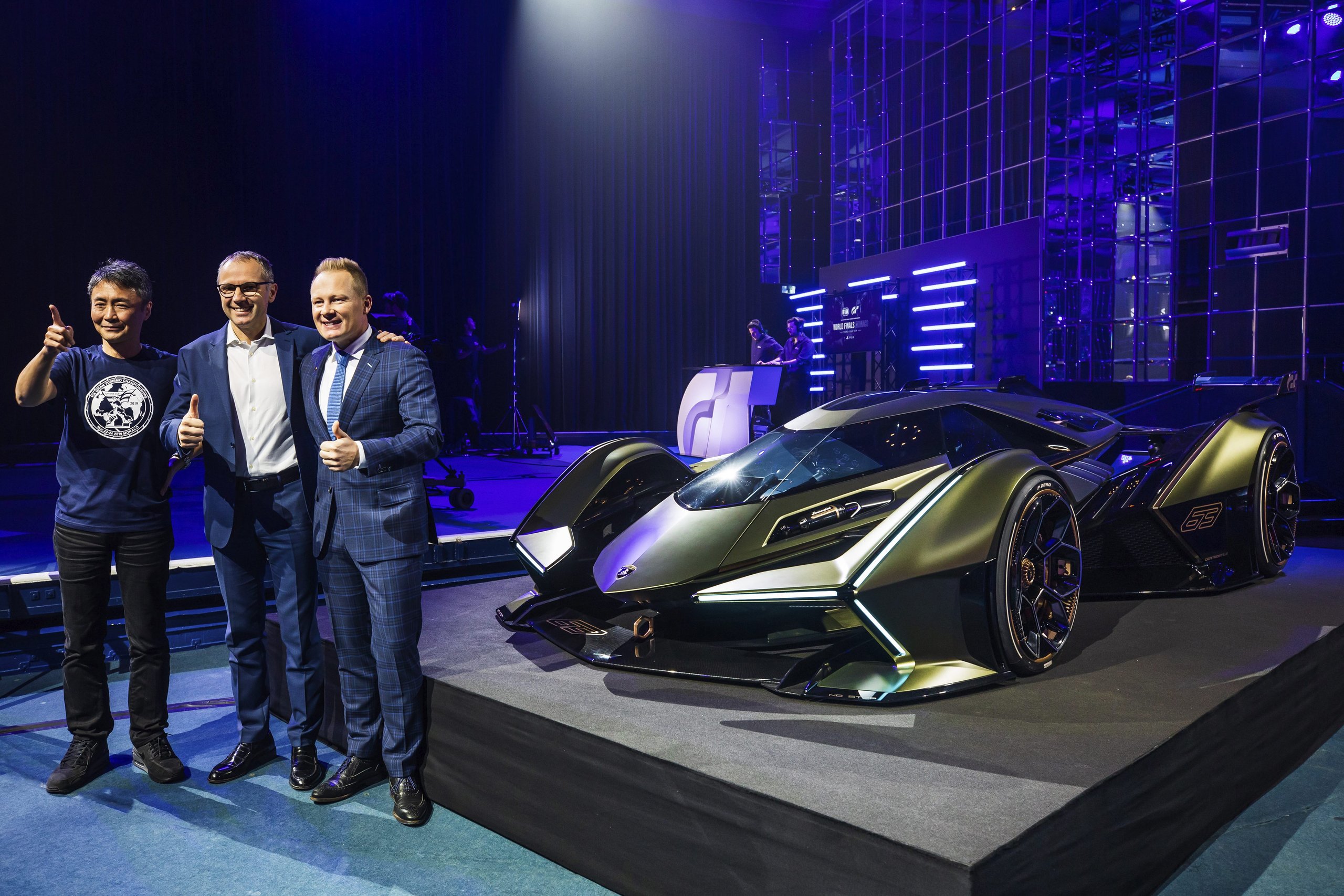 Lamborghini'S V12 Vision Gran Turismo: A Digital Fantasy Built To Recruit The Next Generation 5 Three men posing with thumbs up next to the lamborghini v12 vision gran turismo concept car on the monte carlo unveiling stage