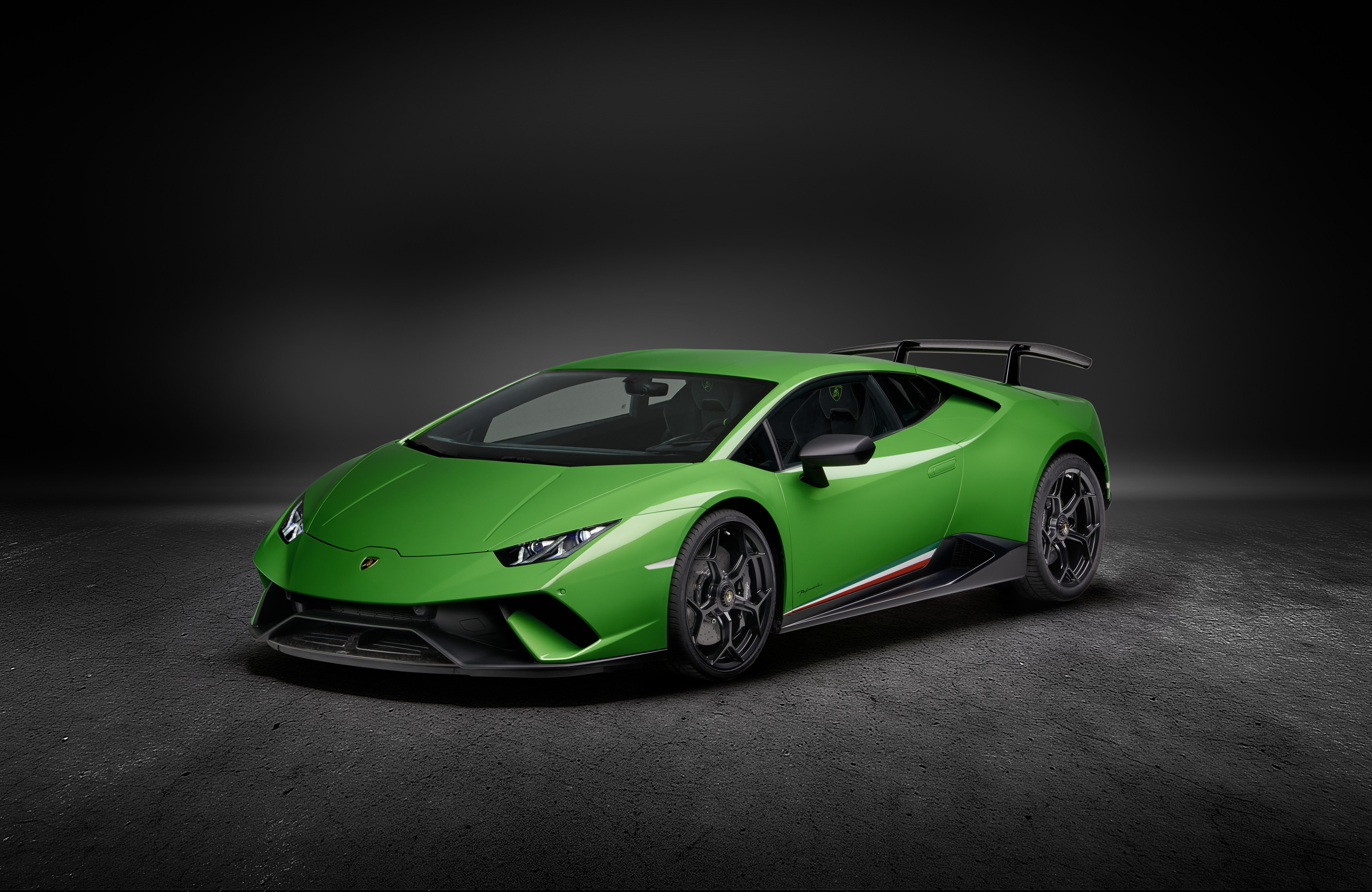 Green Lamborghini Huracán Performante in studio setting showcasing aggressive aerodynamic design