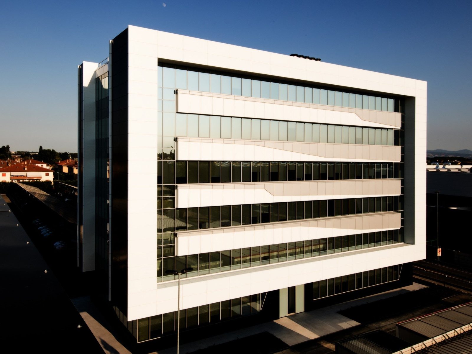 Modern glass and white-paneled office building at Lamborghini's expanded Sant'Agata Bolognese facility