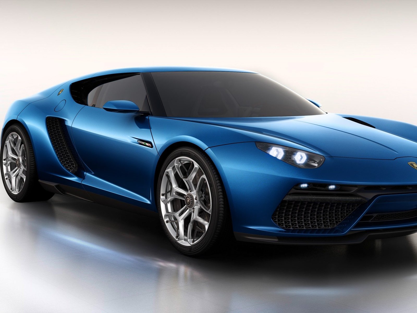 Studio view of the blue Lamborghini Asterion LPI 910-4 showing its GT-inspired silhouette, multi-spoke wheels, and large brake calipers