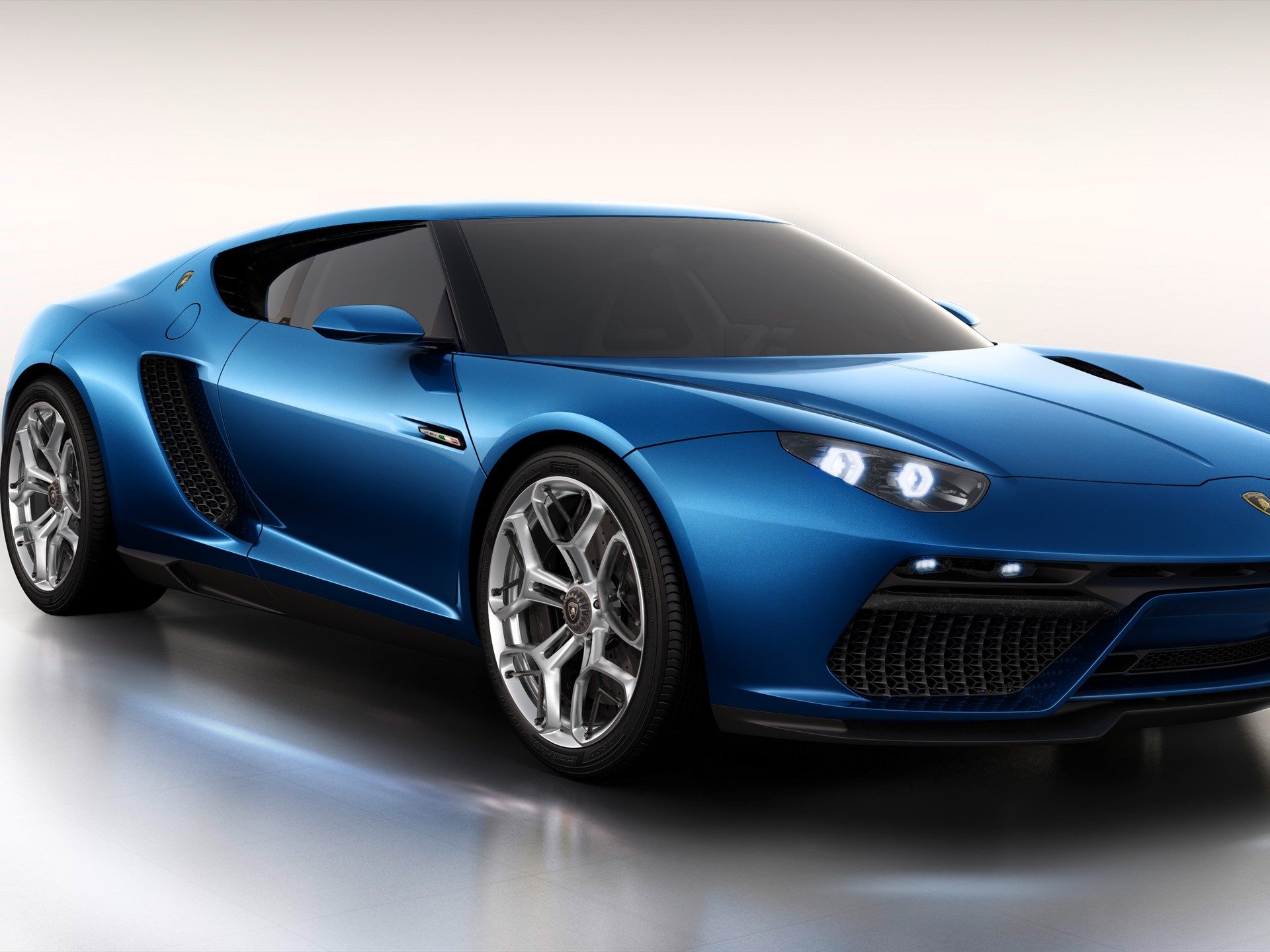 Studio view of the blue Lamborghini Asterion LPI 910-4 showing its GT-inspired silhouette, multi-spoke wheels, and large brake calipers