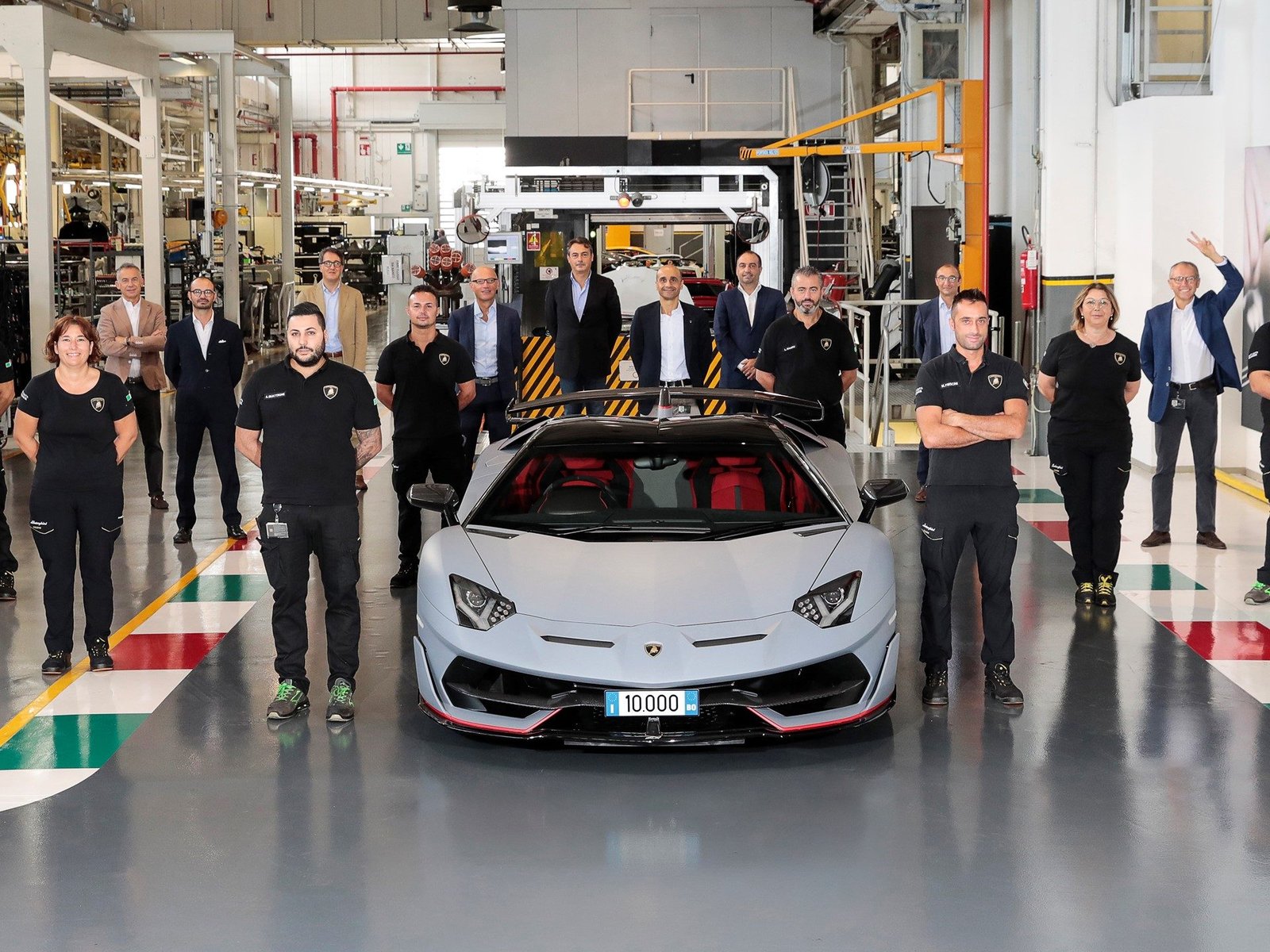 Lamborghini employees celebrate the 10,000th Aventador SVJ Roadster on the Sant'Agata Bolognese factory floor