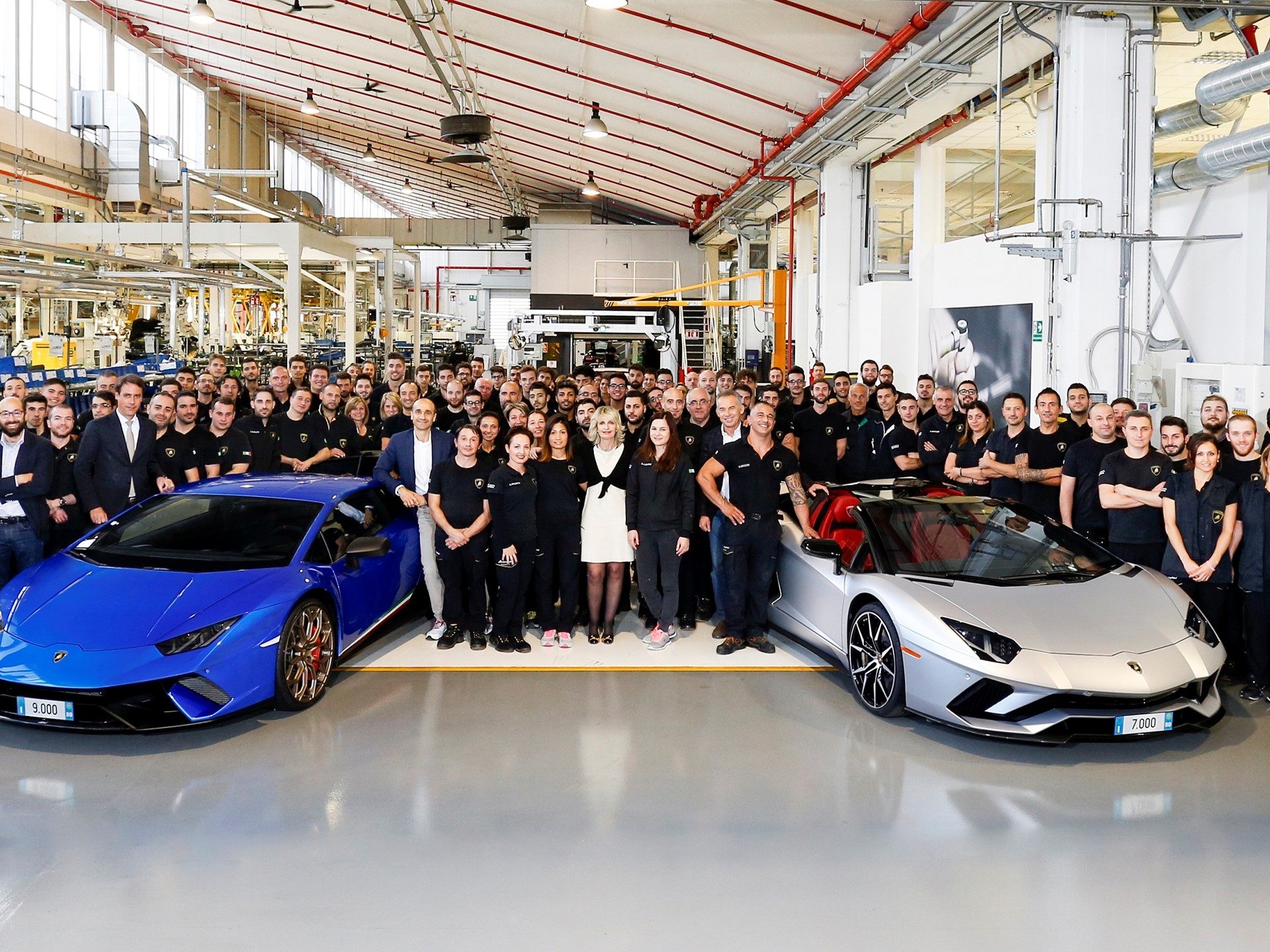 Lamborghini employees celebrate with the 7,000th Aventador in Grigio Adamas and the 9,000th Huracán in Blue Nethuns at the Sant'Agata Bolognese factory