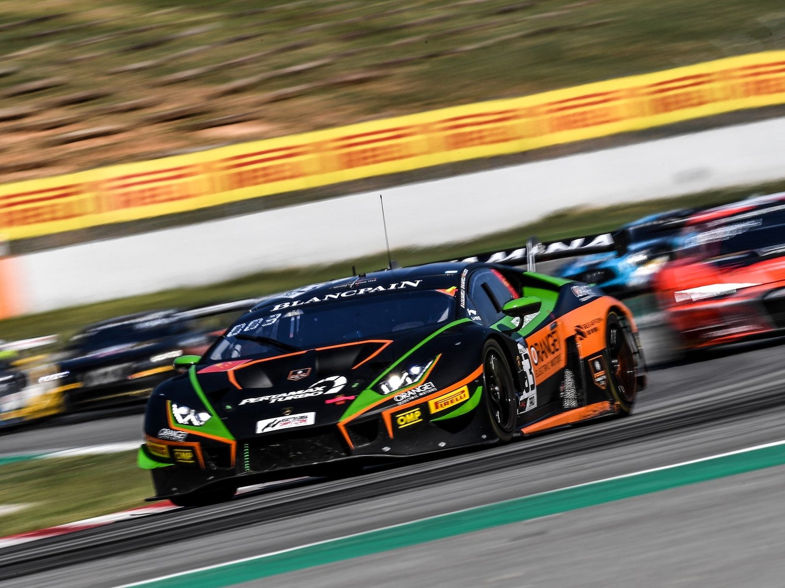 The #63 Lamborghini Huracán GT3 race car leads a pack of competitors on track during the Blancpain GT Series
