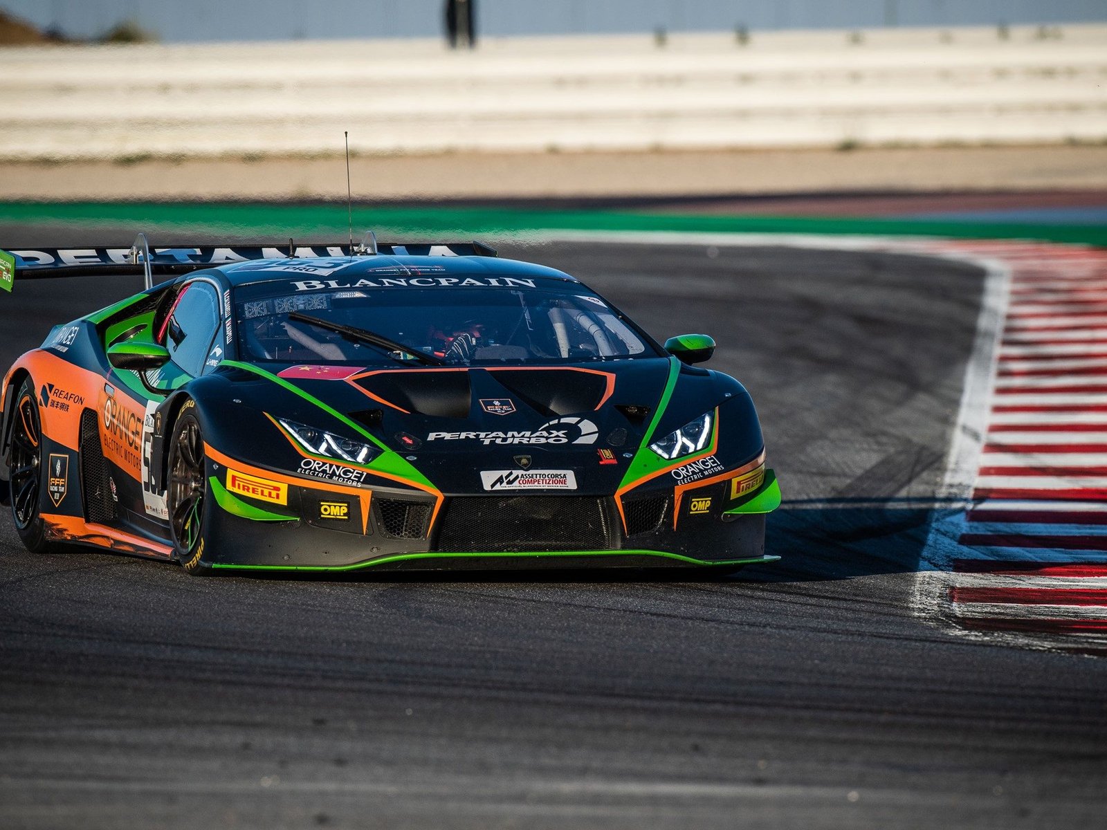 The Orange1 by FFF Racing Lamborghini Huracán GT3 with prominent rear wing and Pirelli racing tires on track at Misano