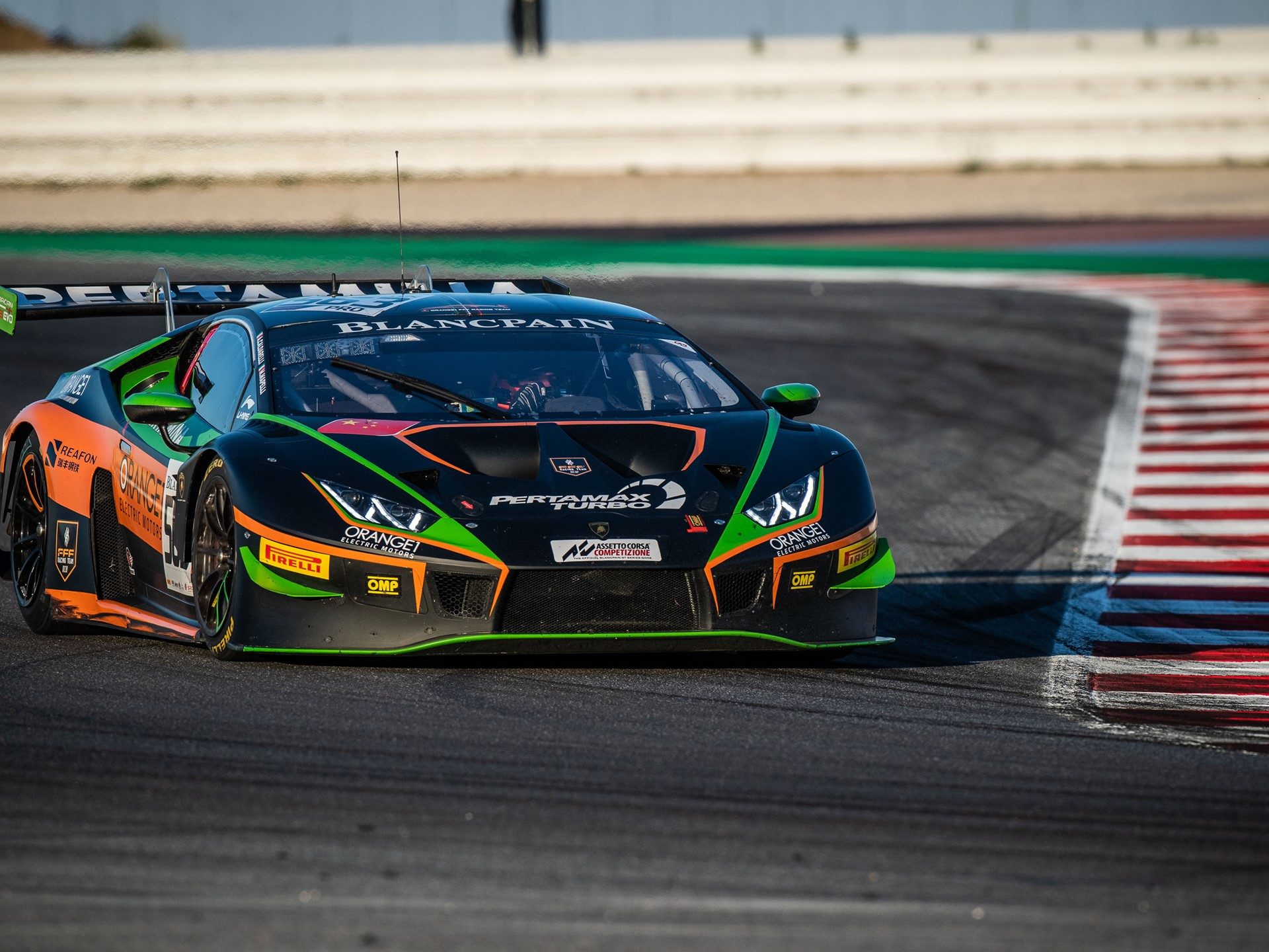 The Orange1 by FFF Racing Lamborghini Huracán GT3 with prominent rear wing and Pirelli racing tires on track at Misano