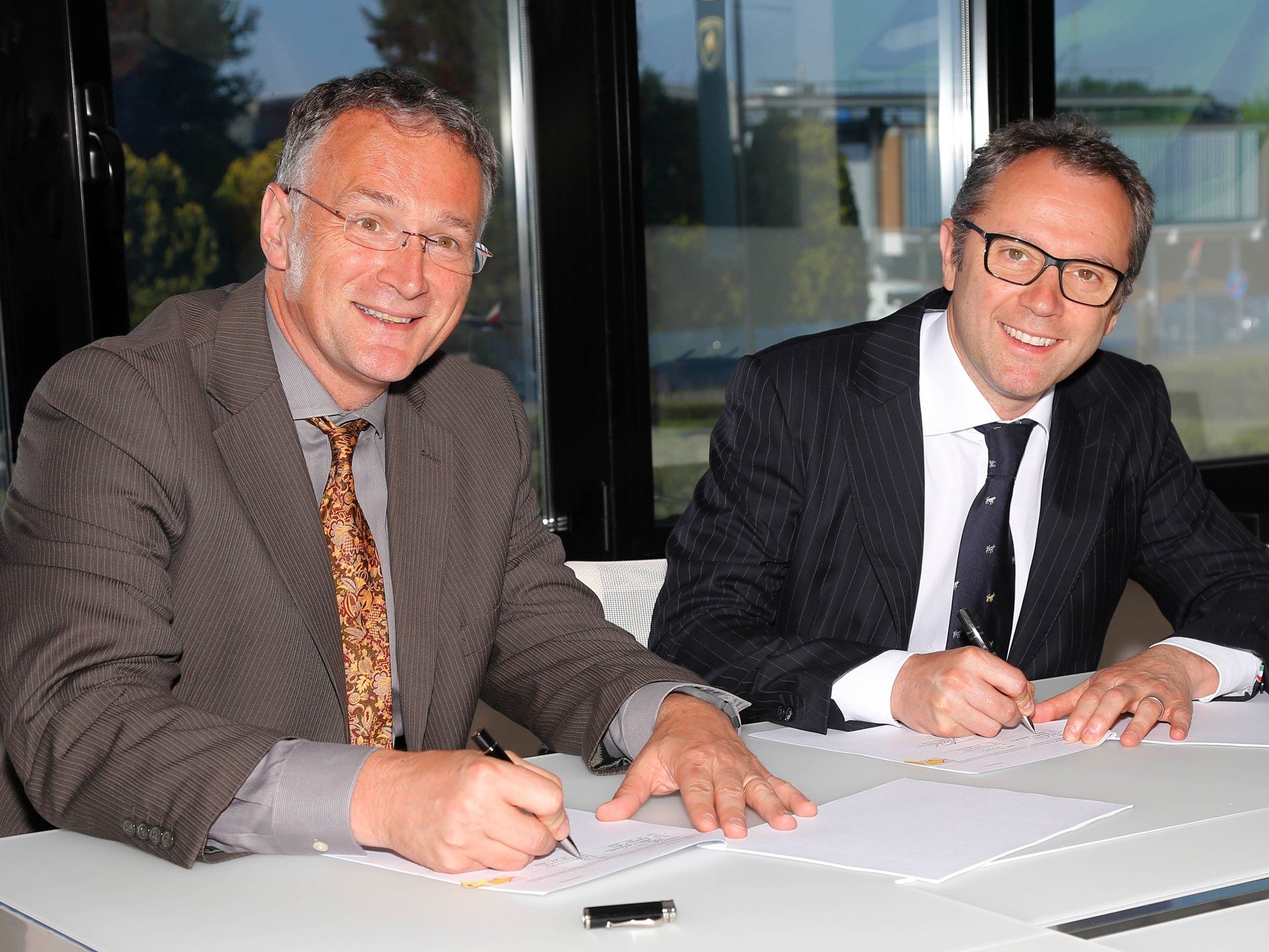 Stefano domenicali and mauro ferrari signing the lamborghini houston methodist carbon fiber research collaboration agreement at sant'agata bolognese