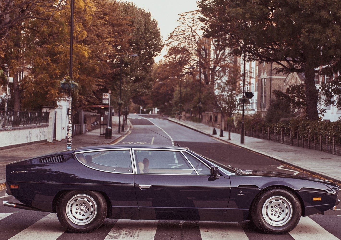 Blue Lamborghini Espada Series III on the Abbey Road zebra crossing in London autumn setting