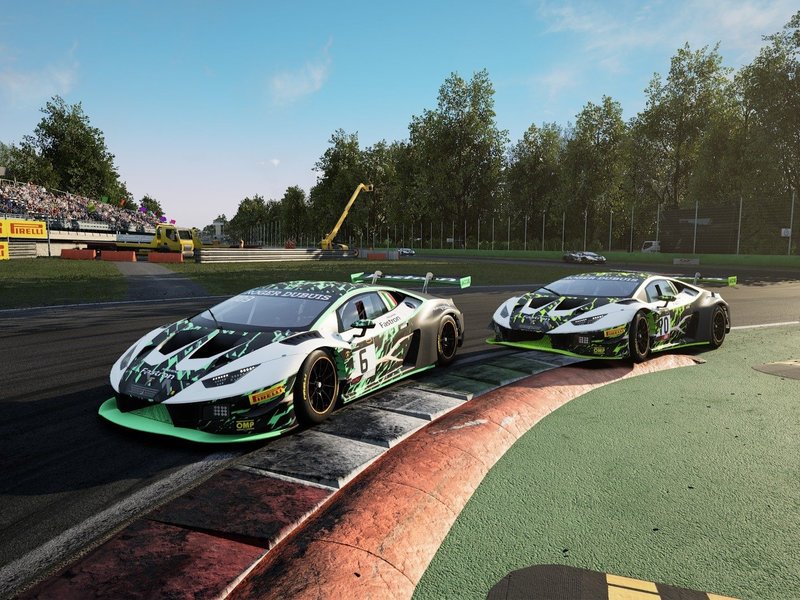 Two Lamborghini Huracán GT3 EVO race cars in white and neon green livery racing on track with spectators in the background