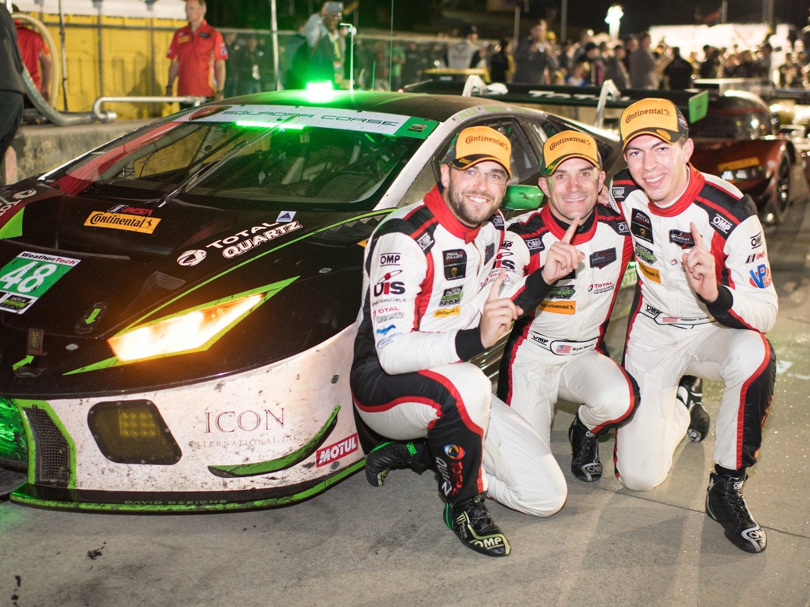 Bryan Sellers, Madison Snow, and Corey Lewis celebrate in front of the No. 48 Paul Miller Racing Lamborghini Huracán GT3 after clinching the 2018 IMSA GTD championship