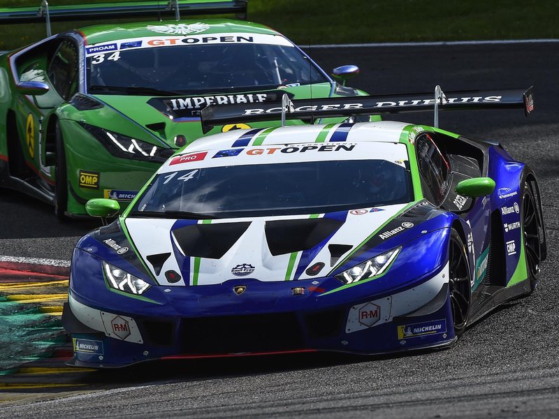 Two Lamborghini Huracán GT3 EVO race cars battling for position on the Spa-Francorchamps circuit during the International GT Open