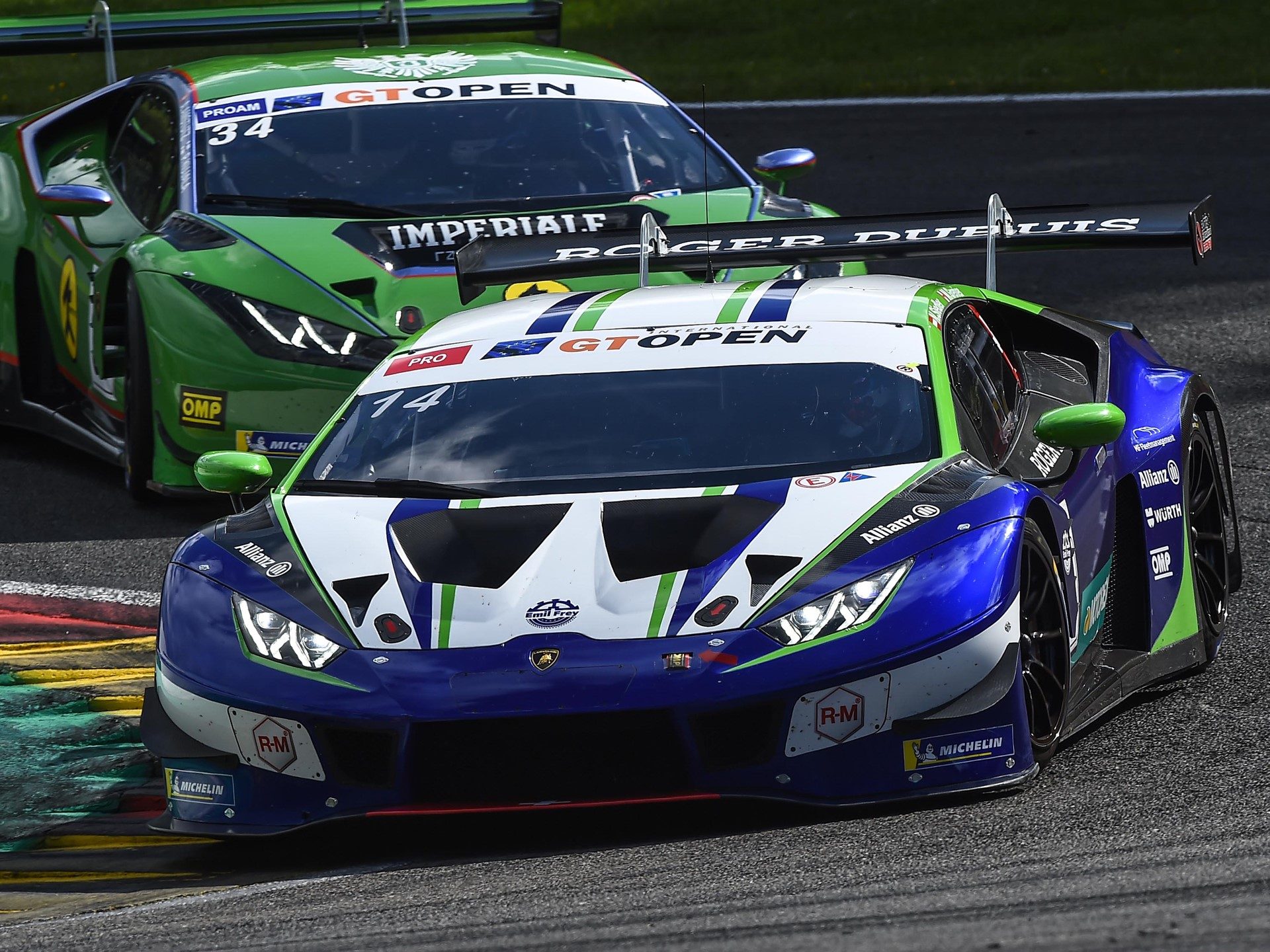 Two lamborghini huracán gt3 evo race cars battling for position on the spa-francorchamps circuit during the international gt open