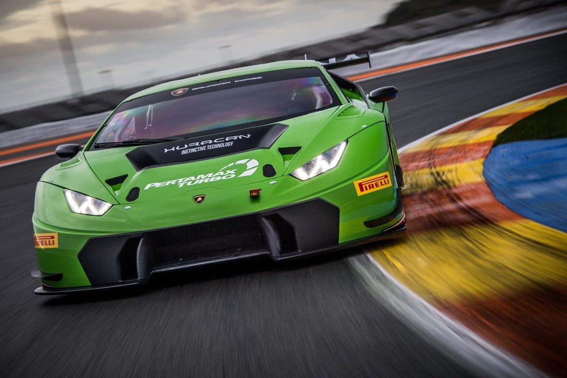 Lamborghini Huracán GT3 in green racing livery cornering hard on track with visible carbon fiber front splitter and rear wing