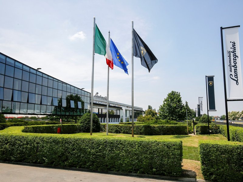 Automobili Lamborghini headquarters in Sant'Agata Bolognese with Italian, EU, and Lamborghini flags