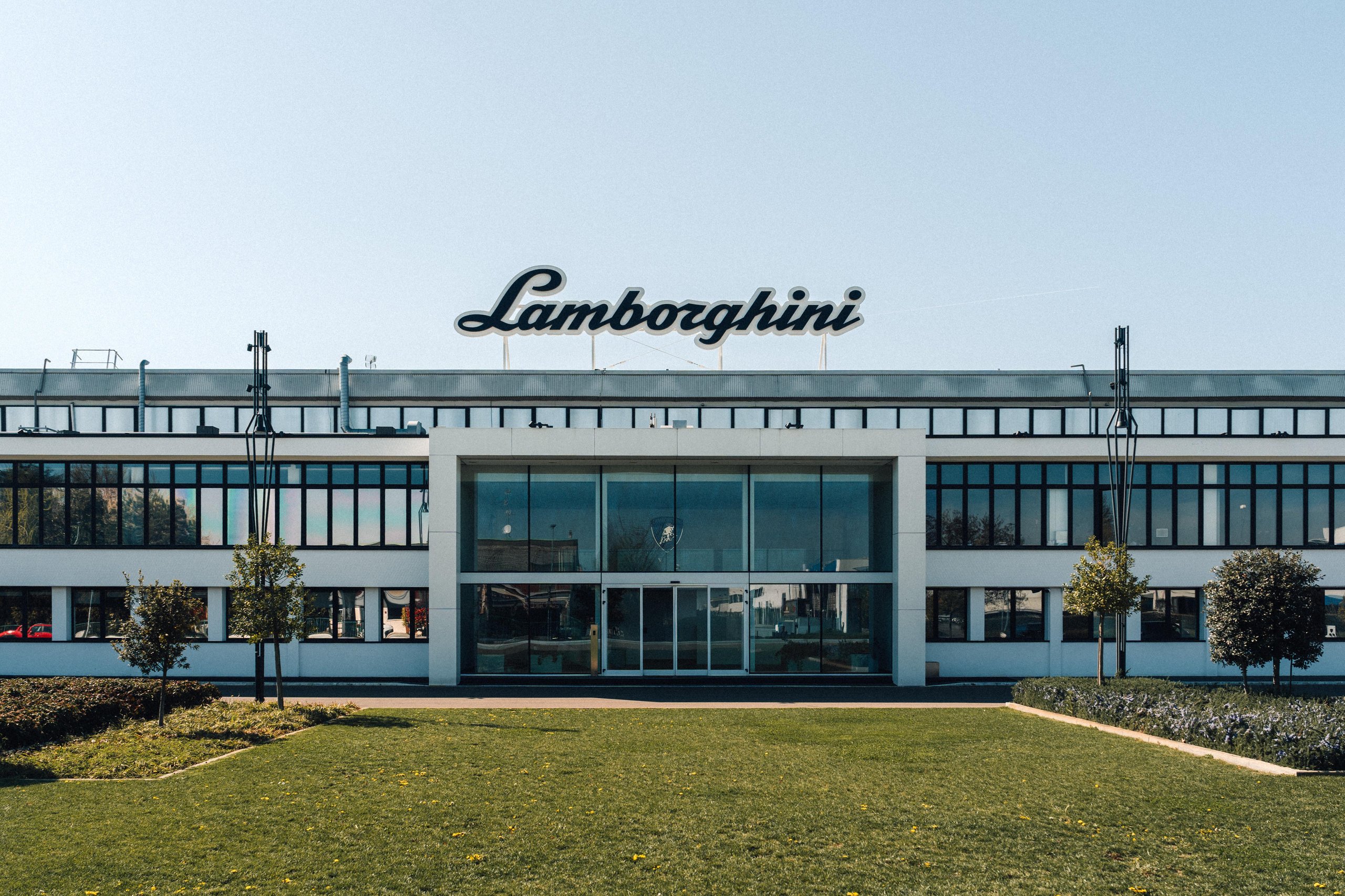 Lamborghini Sold Fewer Cars In H1 2026 And Still Posted Record Revenue. Here'S Why That Matters. 7 Main entrance of the lamborghini factory in sant'agata bolognese with the iconic logo above the doors