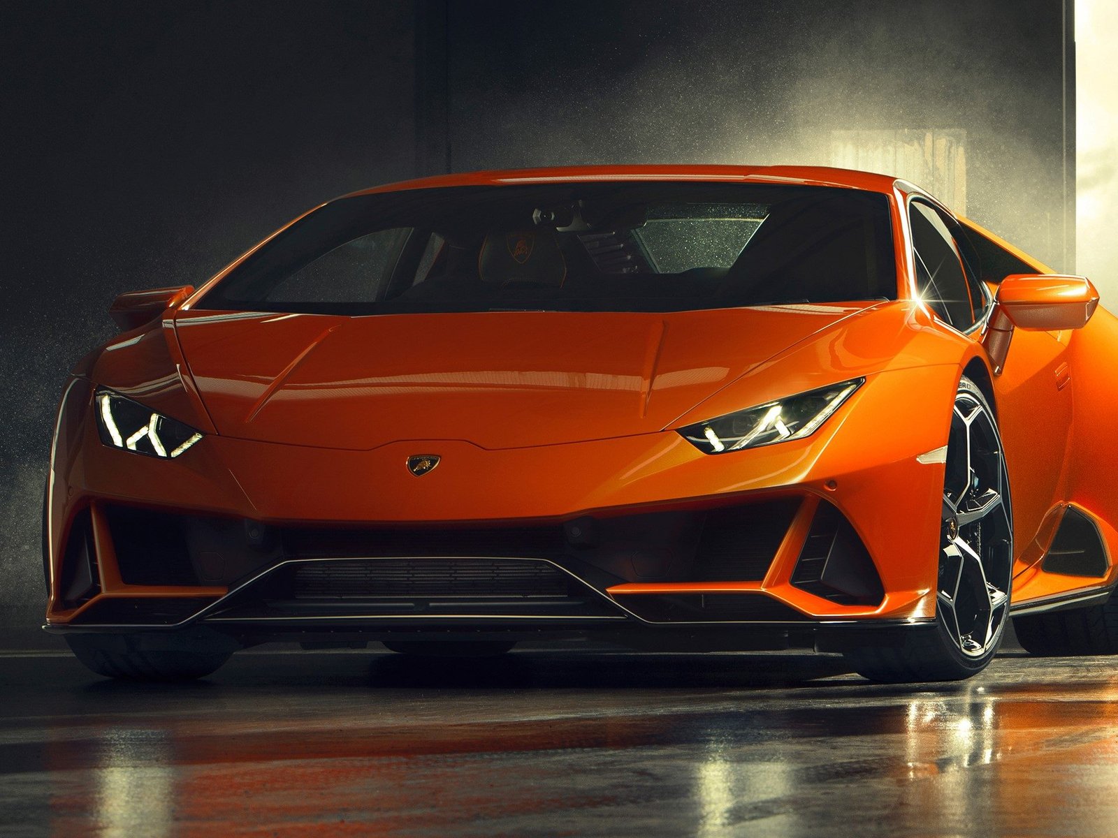 Front view of the Lamborghini Huracán EVO in Arancio Xanto orange, showcasing aggressive front splitter and Y-shaped LED daytime running lights