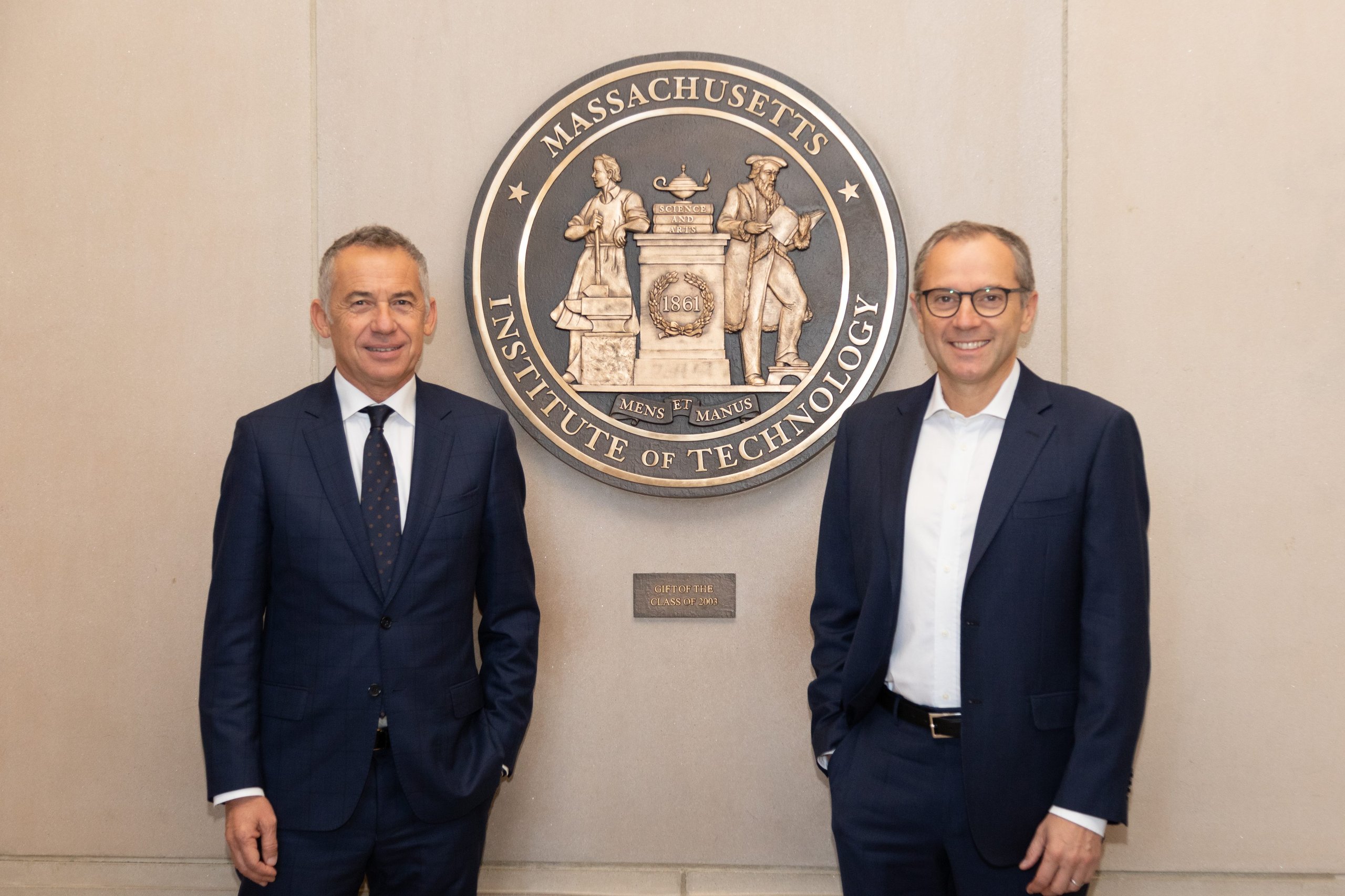 Lamborghini And Mit Patent A Supercapacitor Material That Could Reshape Hypercar Electrification 3 Two men in suits standing in front of the mit seal, representing the lamborghini-mit research partnership