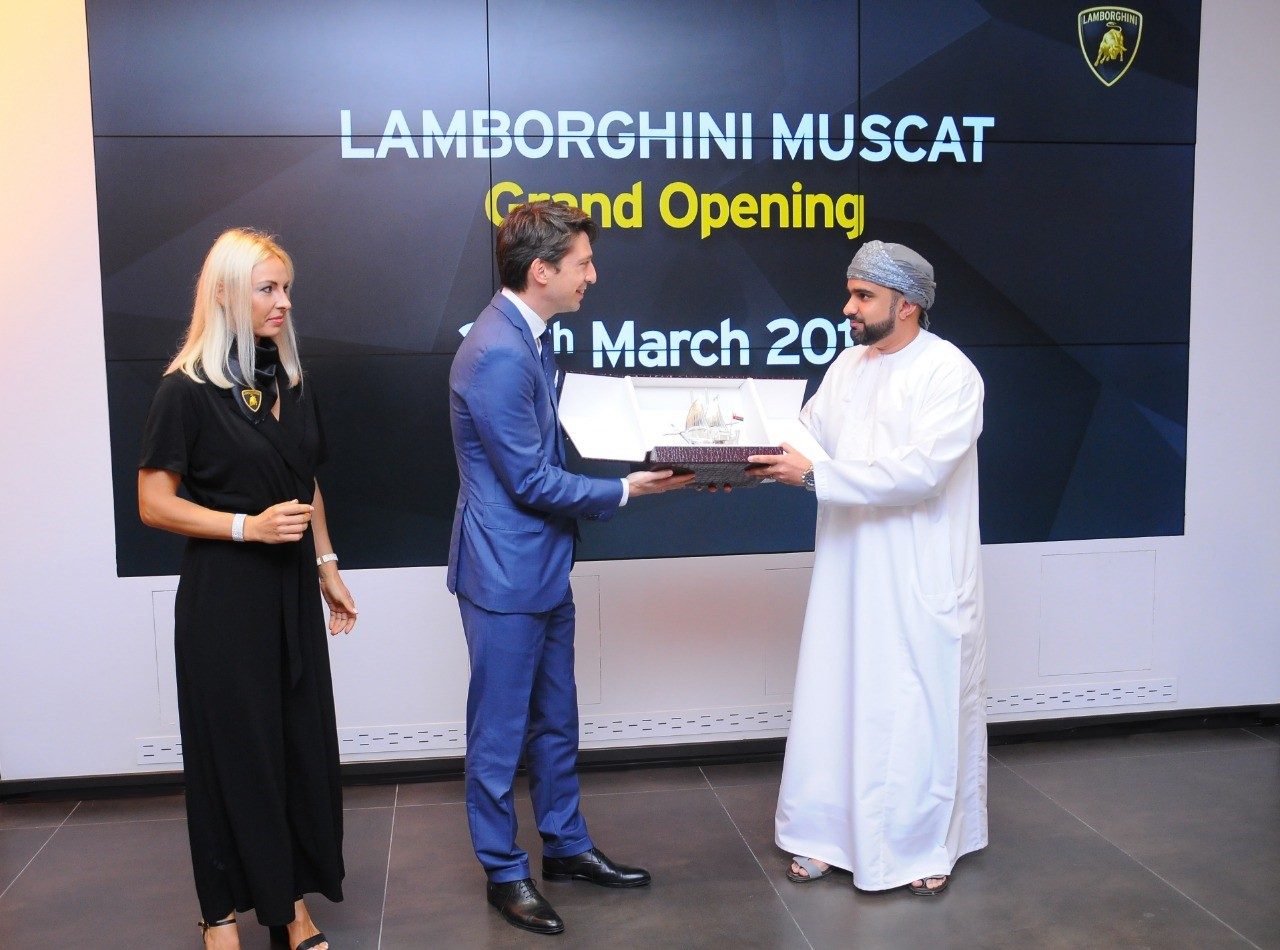 Formal gift exchange between Lamborghini EMEA leadership and Fairtrade Group executives at the Lamborghini Muscat showroom inauguration