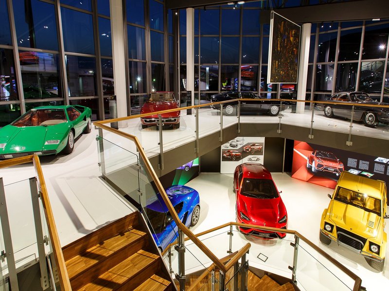 Multi-level Lamborghini Museum interior displaying Countach, LM002, and concept vehicles under natural and artificial lighting