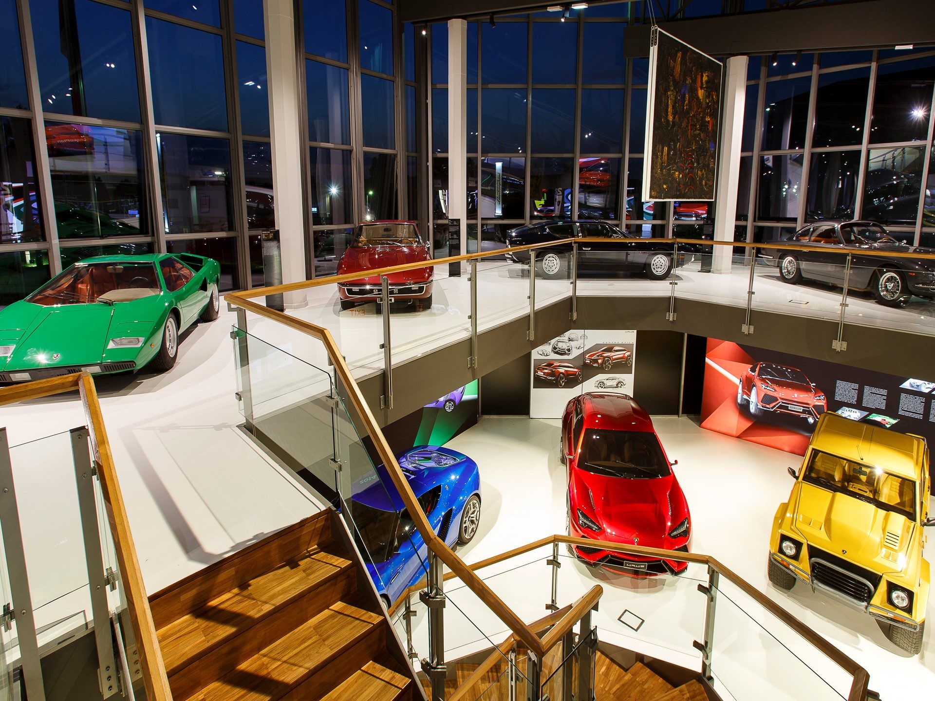 Multi-level Lamborghini Museum interior displaying Countach, LM002, and concept vehicles under natural and artificial lighting