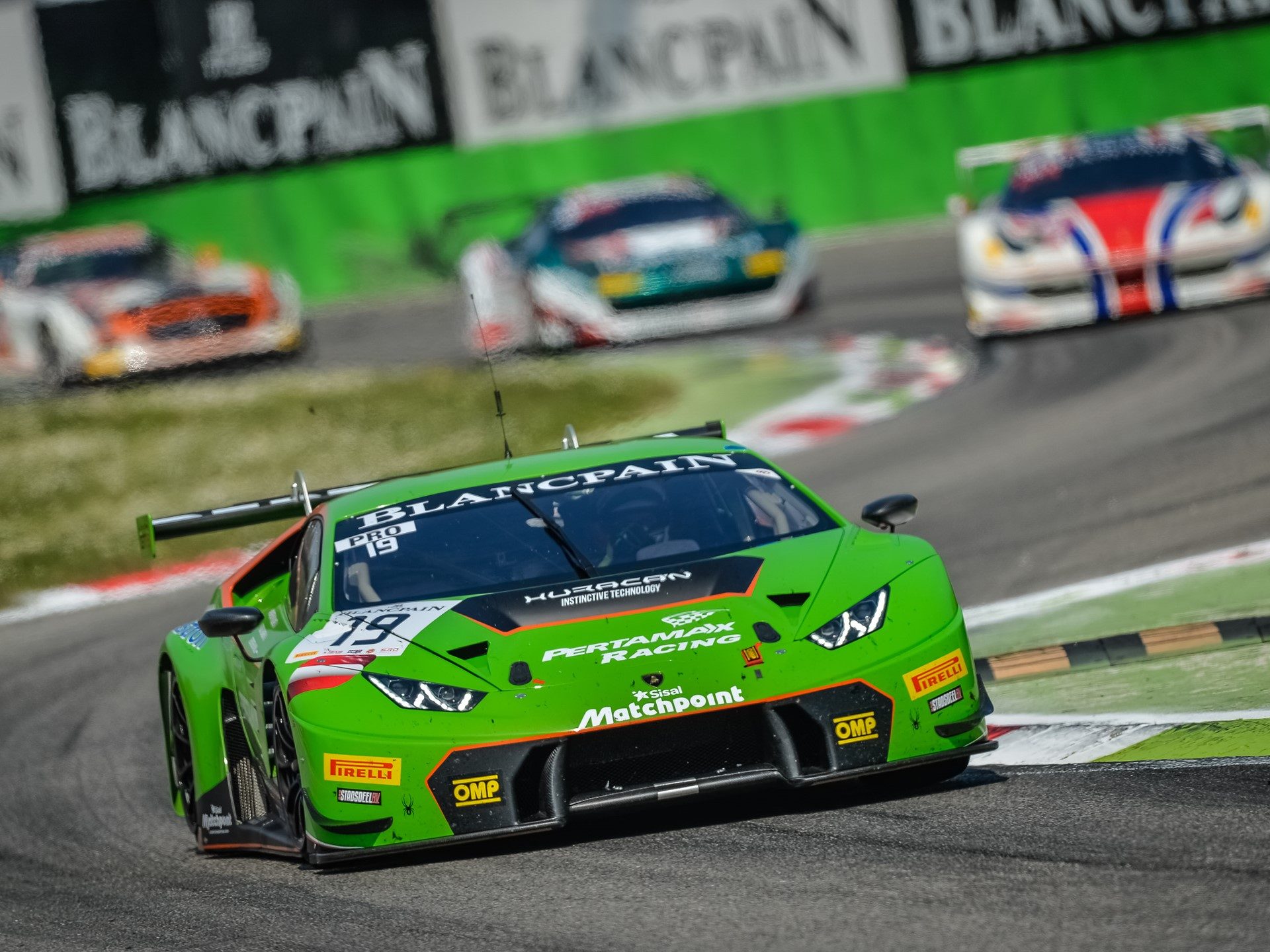 The #19 green Lamborghini Huracán GT3 racing through a corner during the Blancpain Endurance Series at Monza