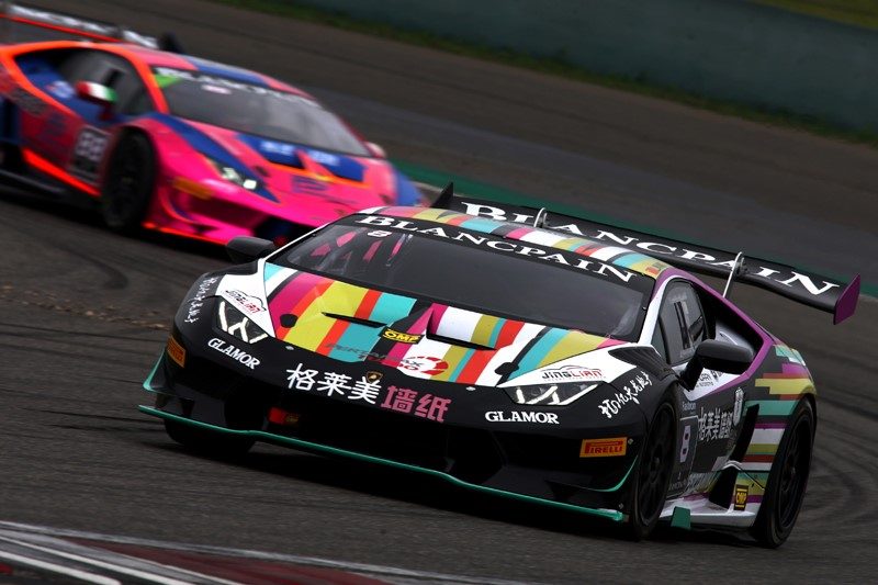 Two Lamborghini Huracán Super Trofeo race cars battle for position on track in vibrant racing liveries