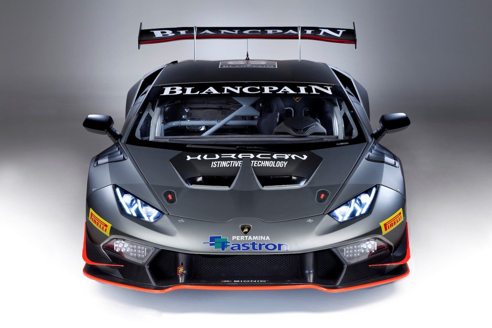 Lamborghini Huracán Super Trofeo race car shown head-on in studio lighting, displaying aggressive aerodynamics and racing livery