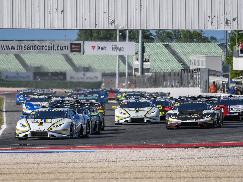A pack of Lamborghini Huracán Super Trofeo race cars battling for position on track at Misano during the 2018 Super Trofeo Europe round