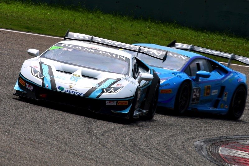 Two Lamborghini Huracán GT3 race cars battling for position on the Shanghai International Circuit