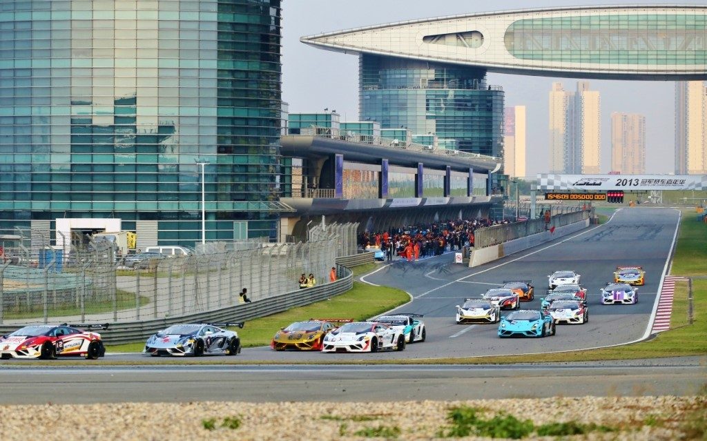 Multiple Lamborghini Gallardo Super Trofeo race cars battling on track during a Blancpain Super Trofeo Asia Series event with spectators visible in grandstands