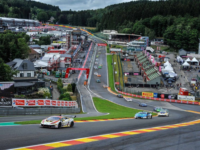 Aerial view of multiple Lamborghini Huracán Super Trofeo race cars battling through a corner at Spa-Francorchamps during the 2016 Blancpain Super Trofeo Europe