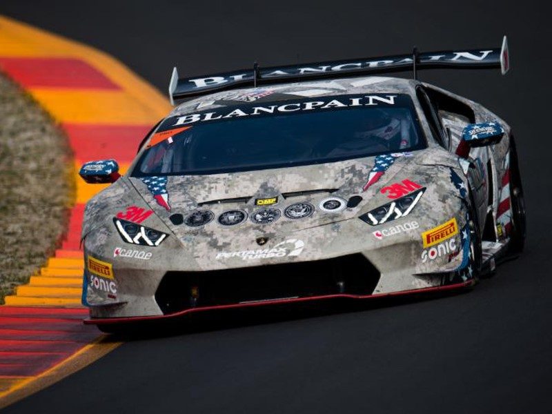 Lamborghini Huracán Super Trofeo race car with aggressive aerodynamics and prominent rear wing racing on track