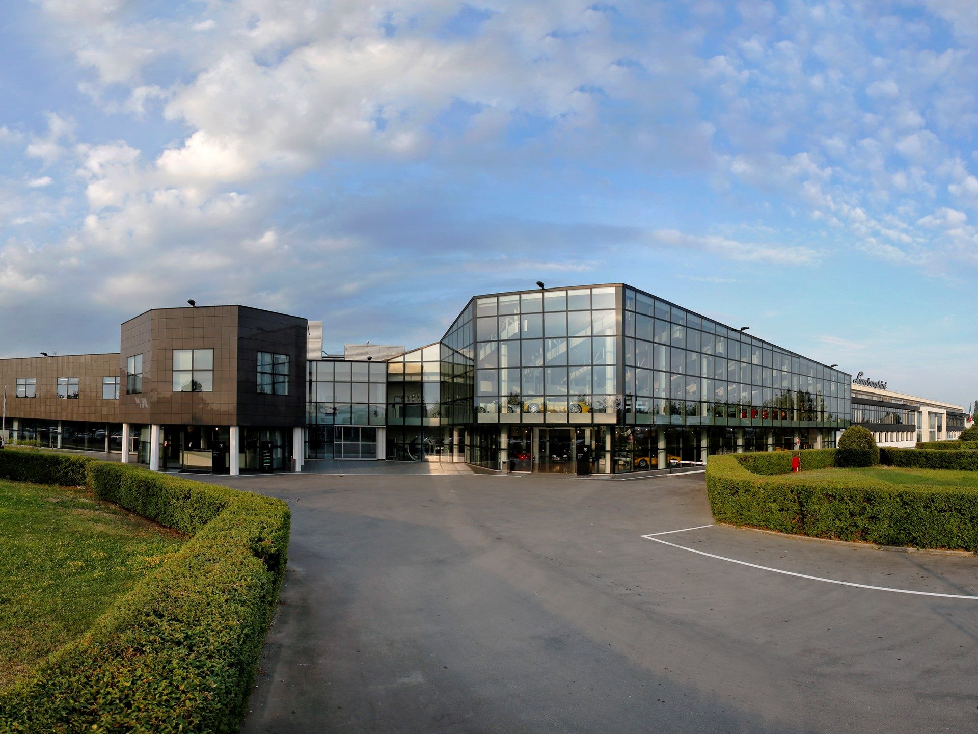 Modern Lamborghini factory building in Sant'Agata Bolognese with glass facade and dark paneling