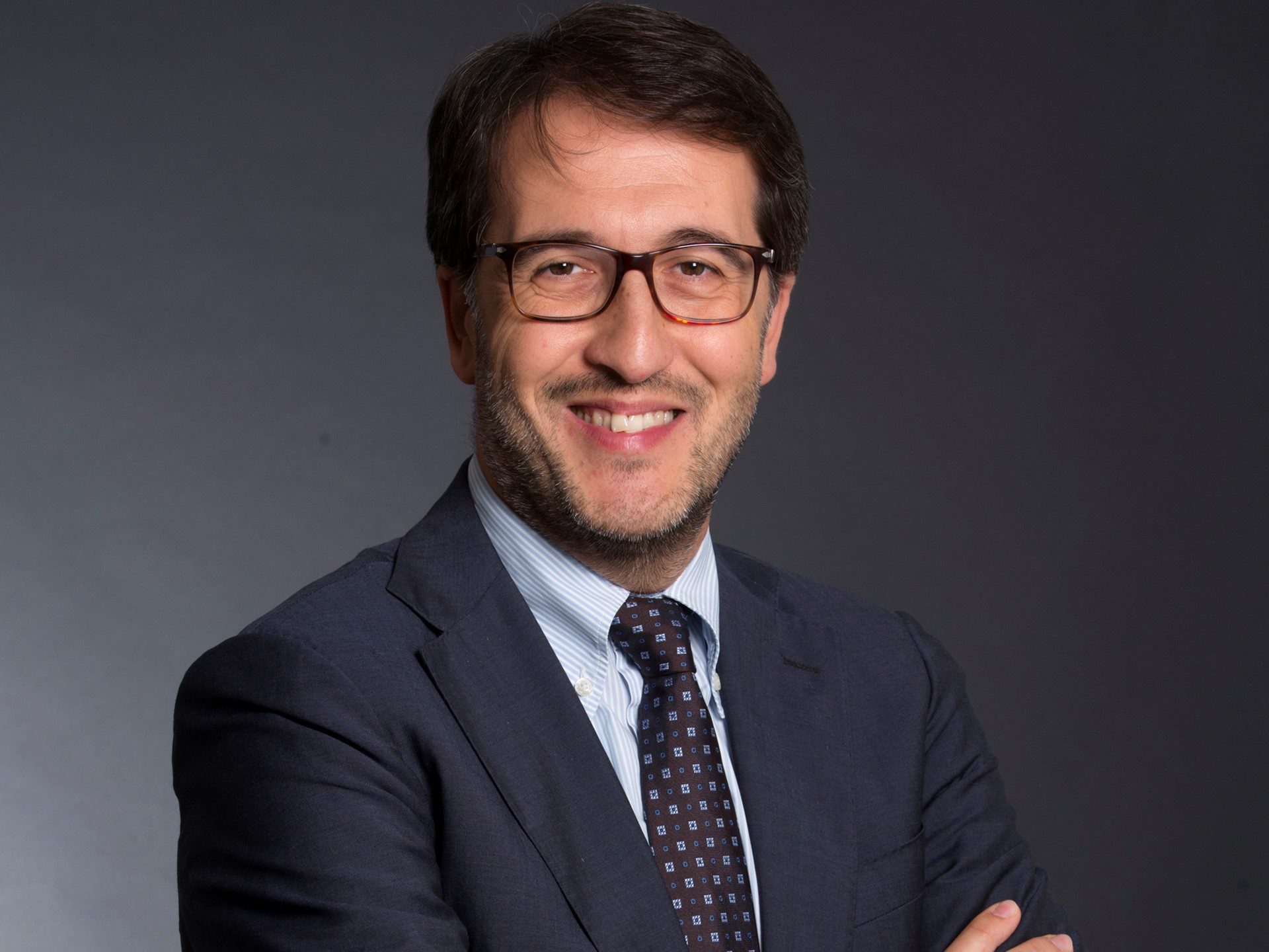 Seven Consecutive Years As Italy'S Top Employer: How Lamborghini'S People Strategy Builds Better Cars 5 Portrait of a lamborghini executive in a suit and glasses against a dark grey background