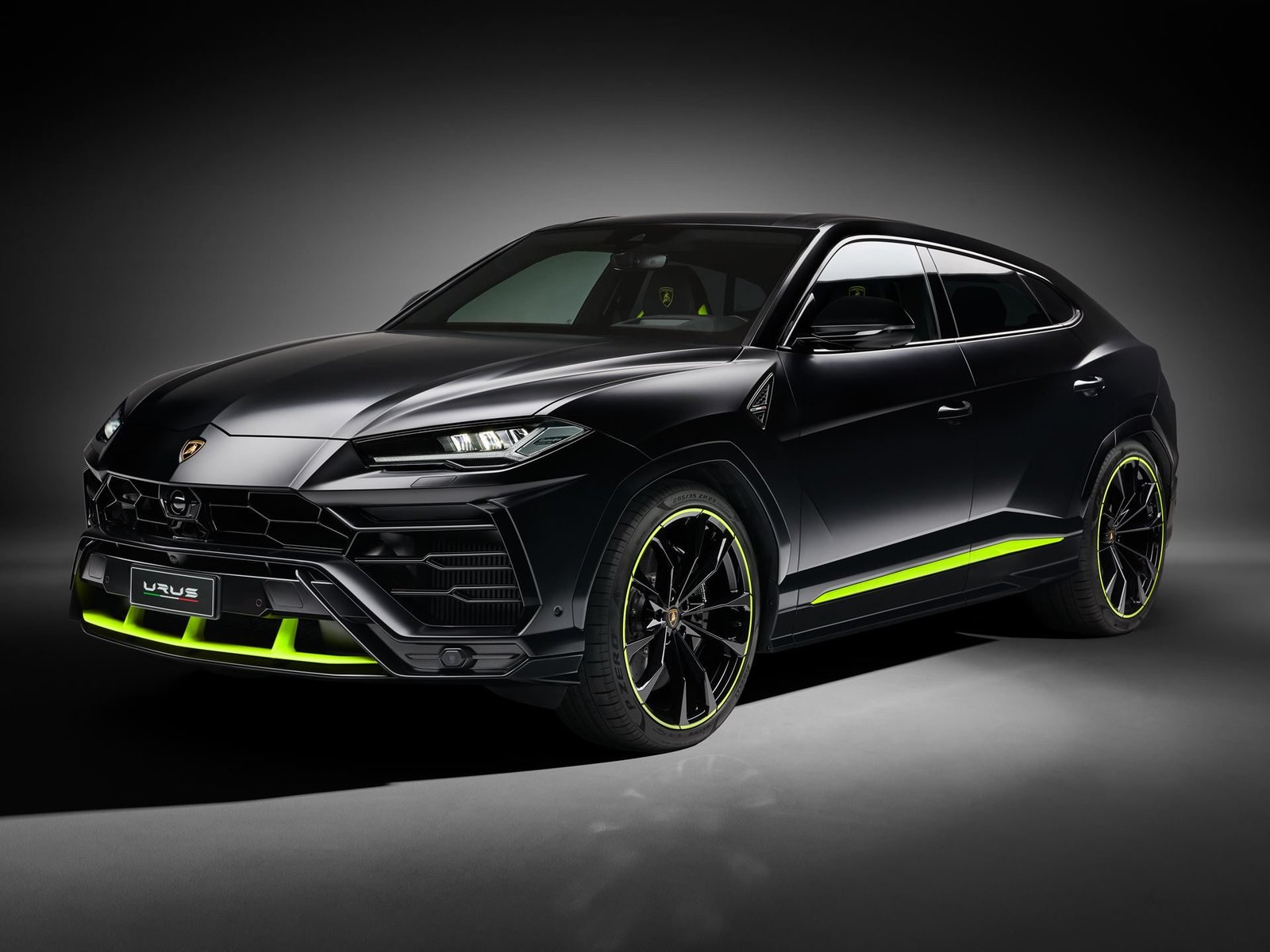 Lamborghini Urus Graphite Capsule in matte black with vivid green accent details on the front splitter, side sills, and 23-inch Taigete wheels