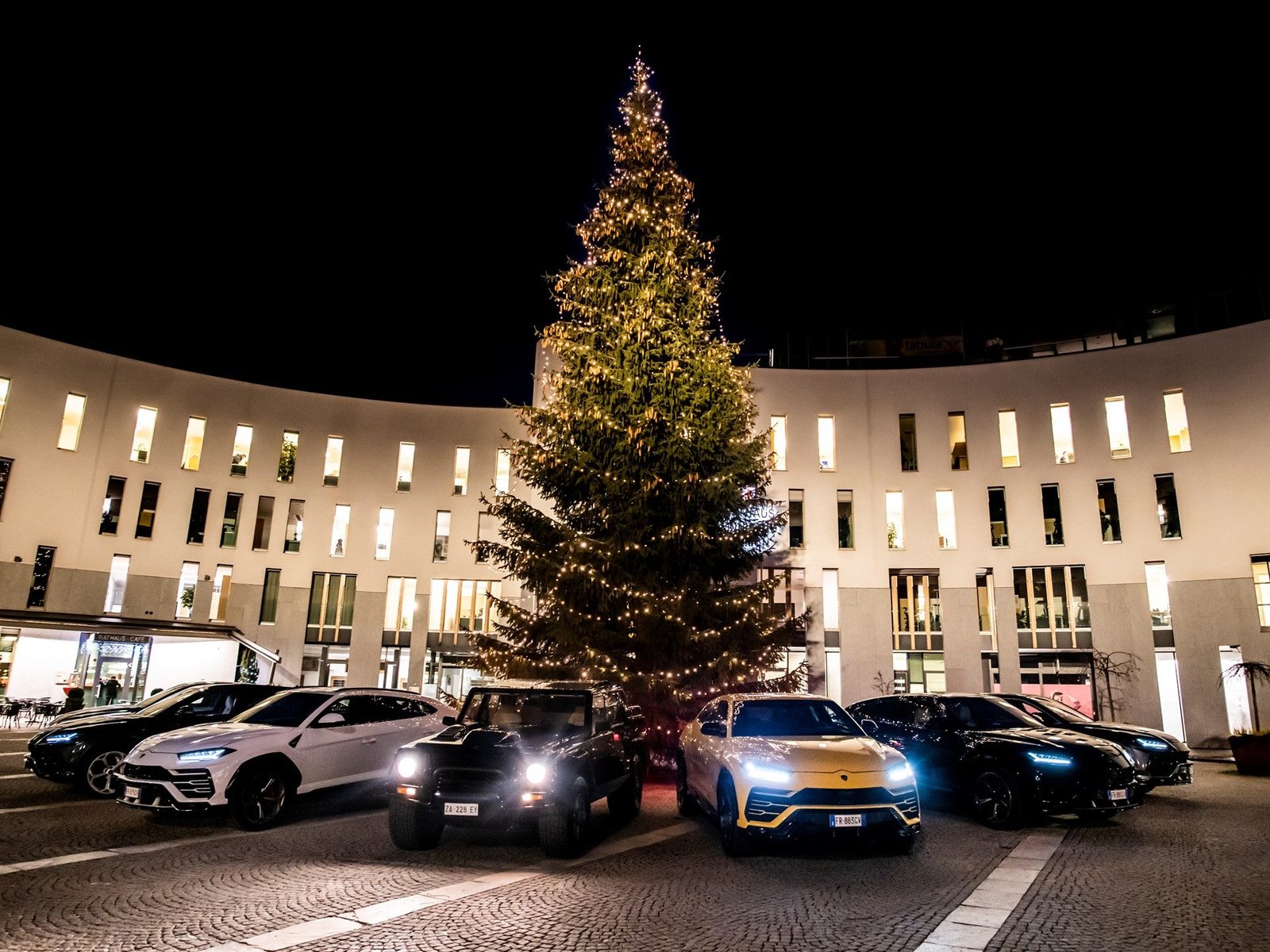Lamborghini Urus fleet alongside the classic LM002 under a large illuminated Christmas tree at the 2018 Christmas Drive event