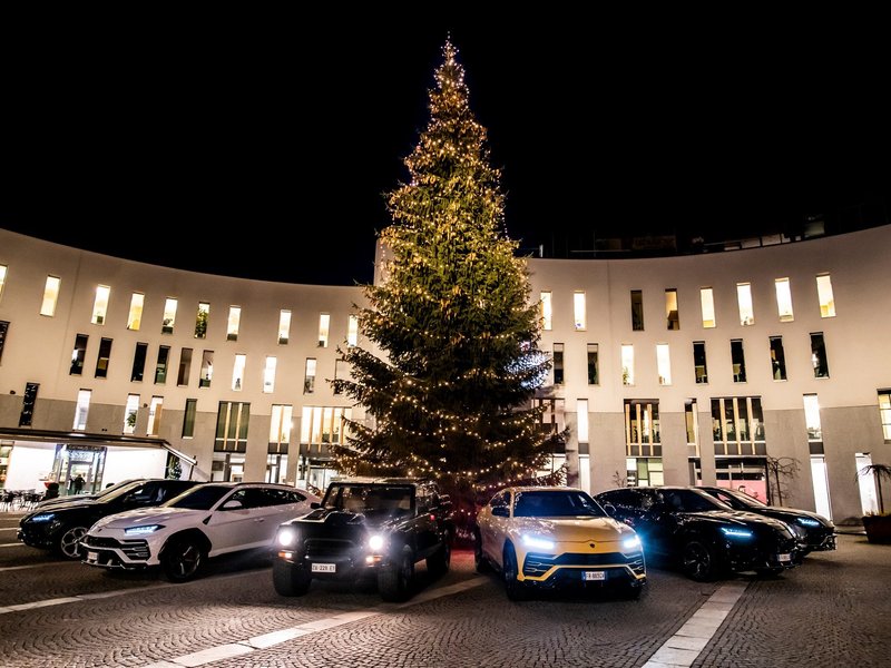 Lamborghini Urus fleet alongside the classic LM002 under a large illuminated Christmas tree at the 2018 Christmas Drive event