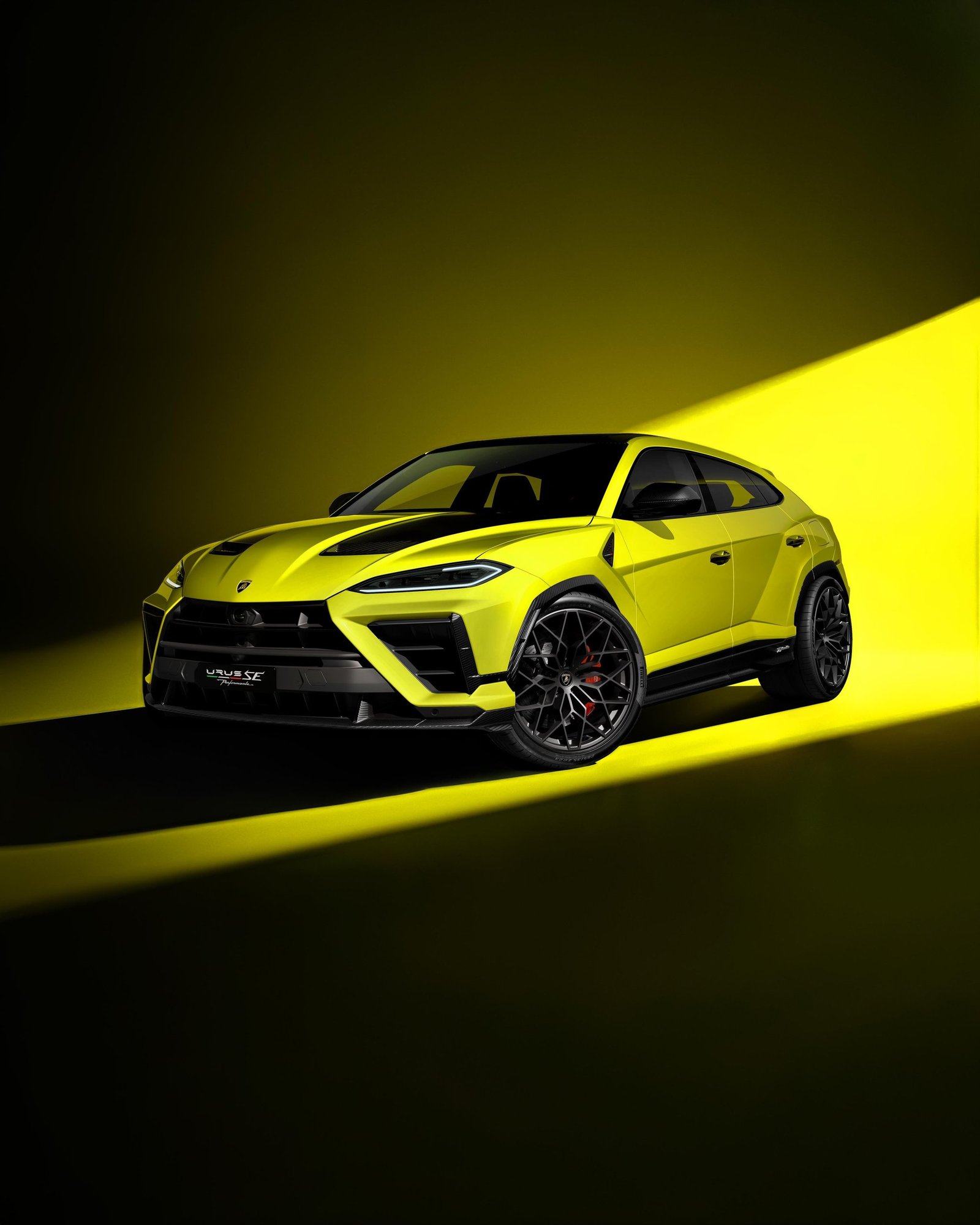 Lamborghini Urus SE Performante in lime green, front three-quarter studio shot showing carbon fiber hood and aggressive front fascia