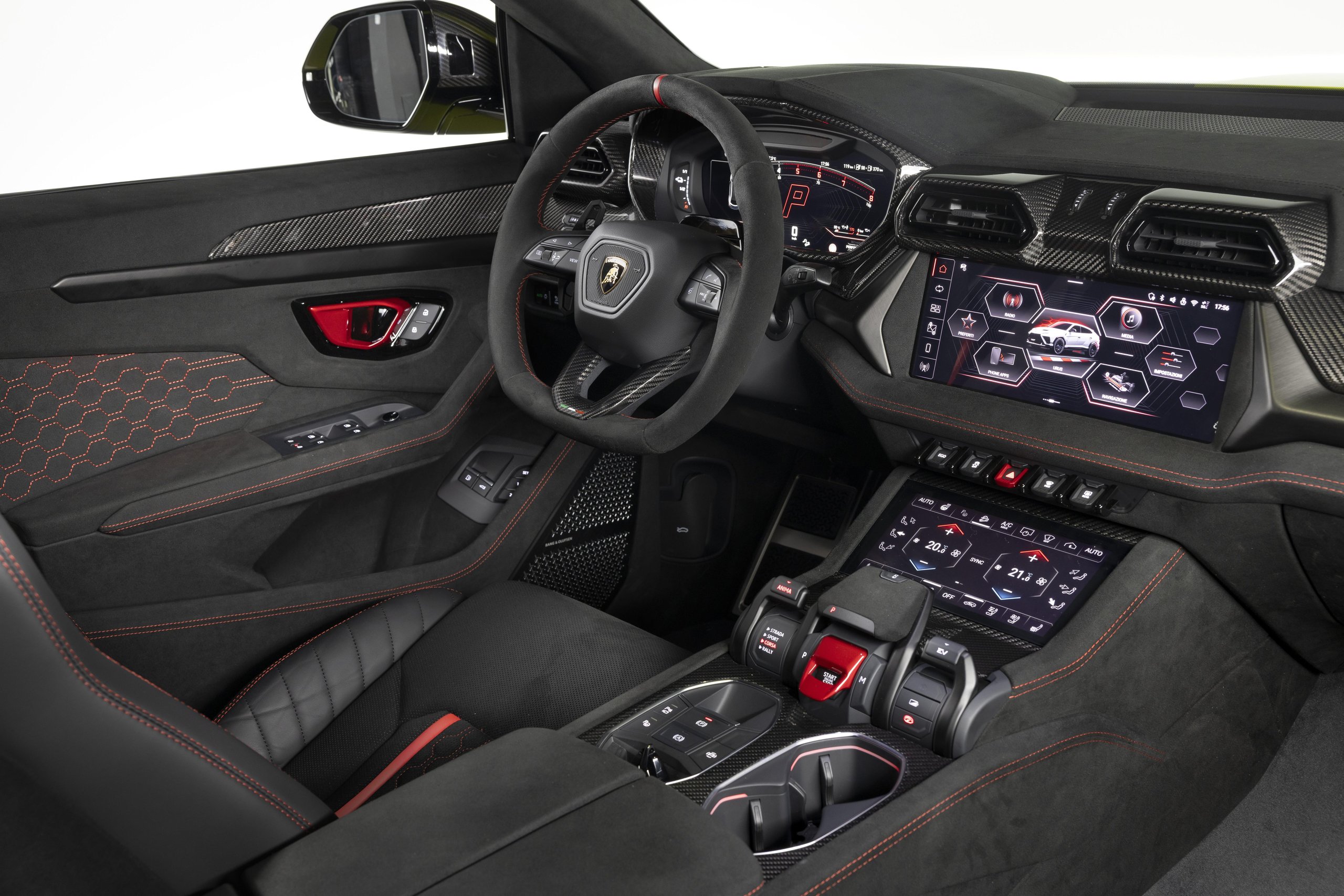 Lamborghini urus se performante interior showing carbon fiber trim, red stitching, digital displays, and fighter jet-inspired center console controls