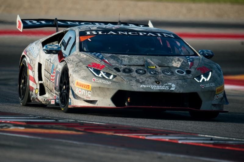 Lamborghini Huracán Super Trofeo race car in grey camouflage livery with large rear wing and racing slicks on track at COTA