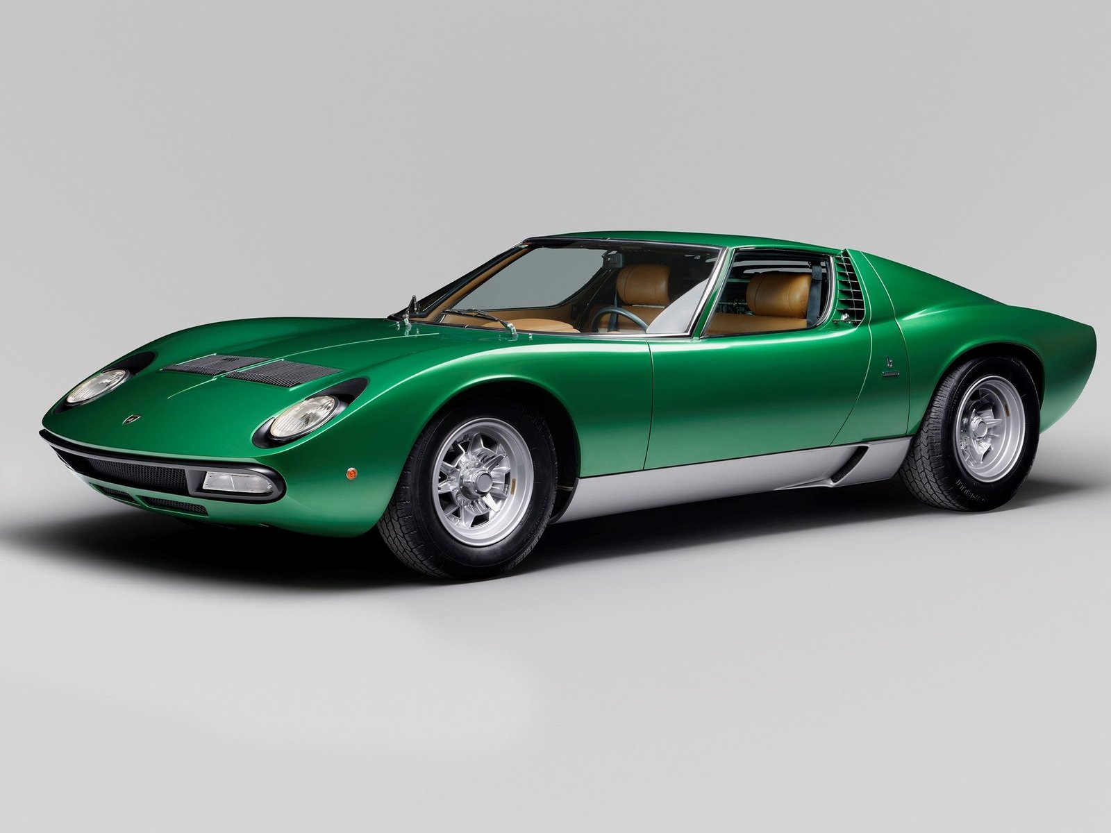 Lamborghini Miura SV #4846 in Verde Metallizata showing its distinctive eyelash headlights and sleek side profile after Polo Storico restoration