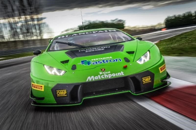 Lamborghini Huracán GT3 in green livery racing on circuit, showing large front splitter and aerodynamic body kit