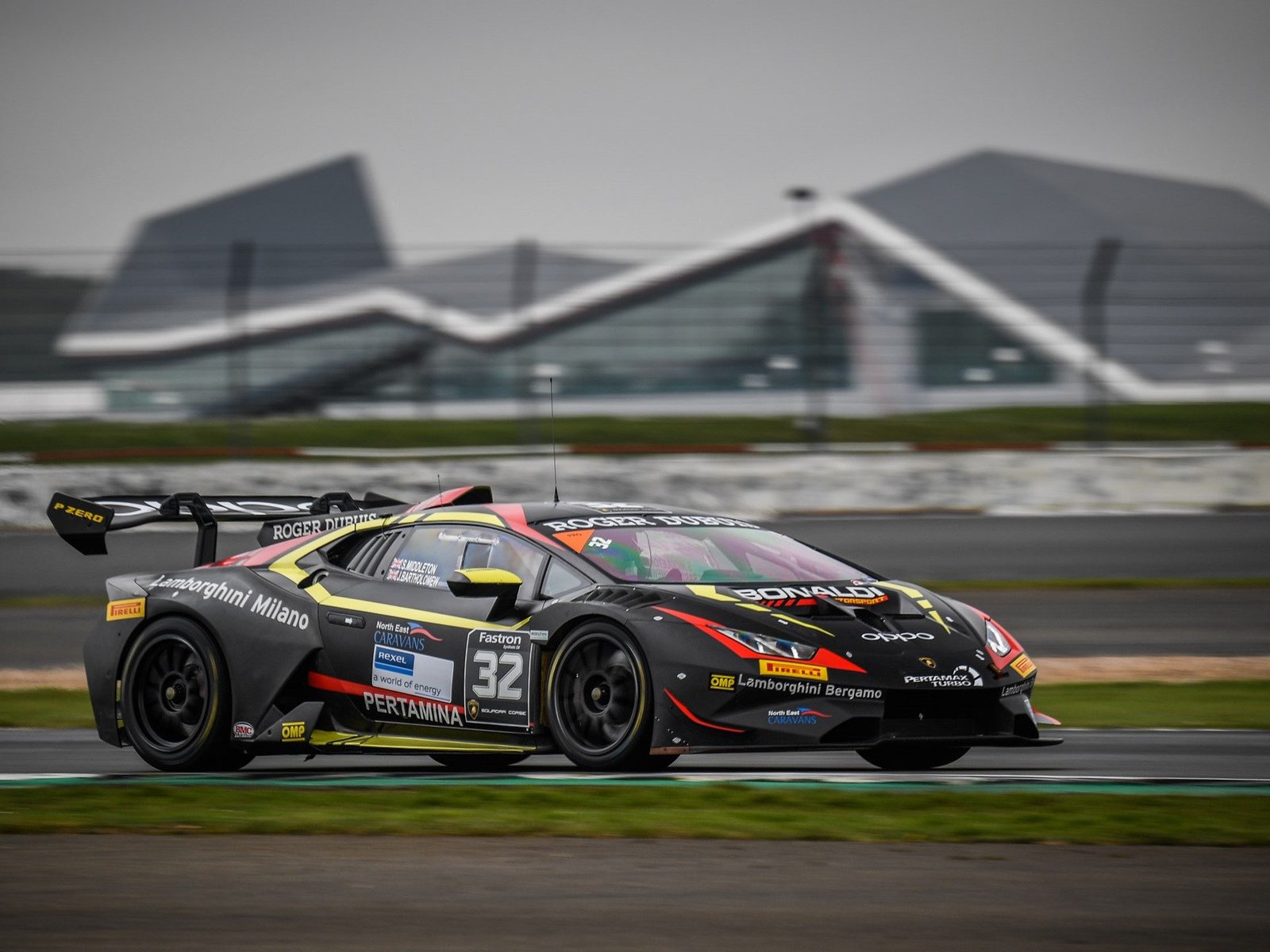 The #32 Bonaldi Motorsport Huracán Super Trofeo EVO2 at speed, showing its aggressive aero kit, large rear wing, and Pirelli racing slicks