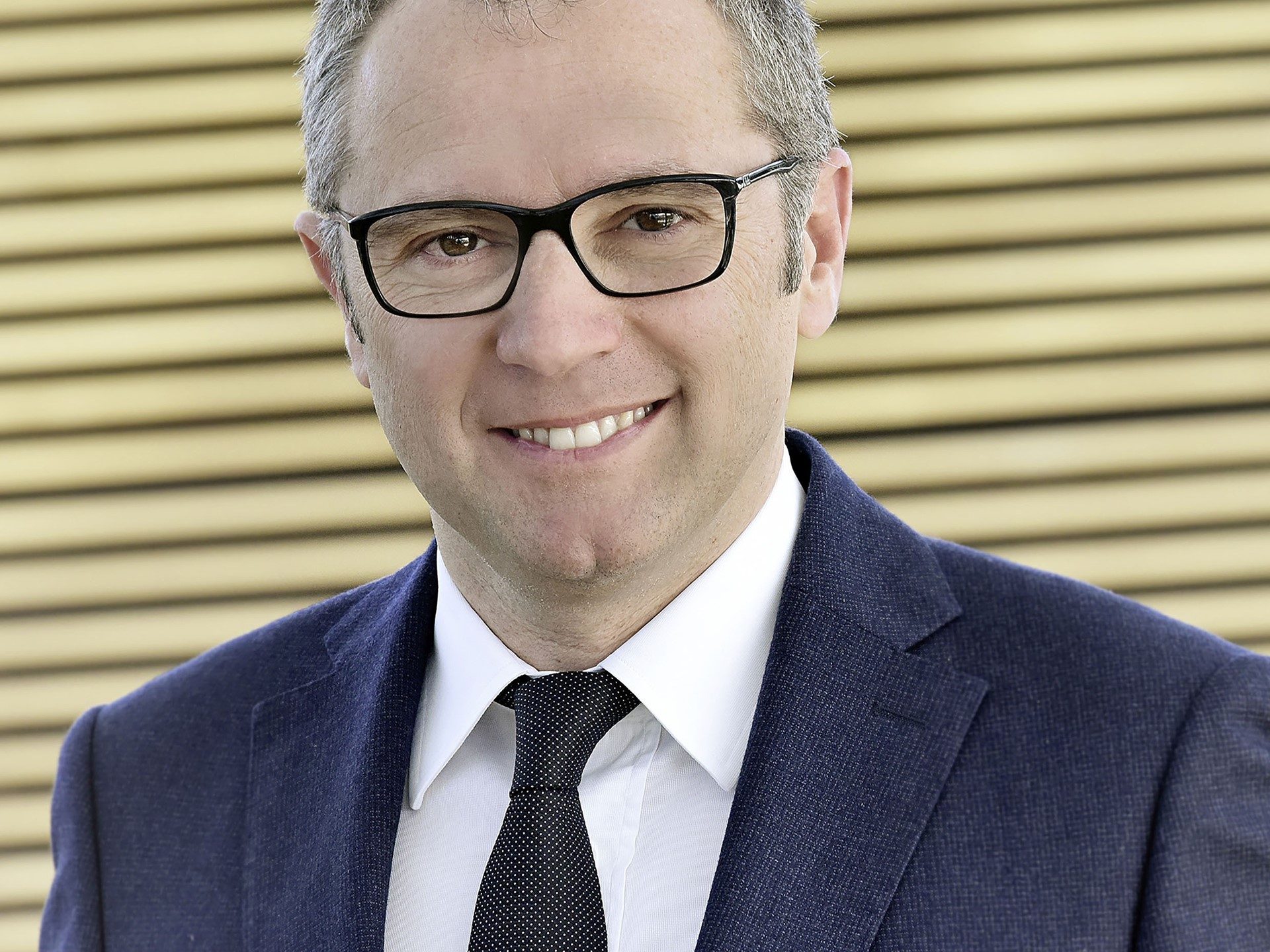 Stefano Domenicali, newly appointed President and CEO of Automobili Lamborghini, in a blue suit and glasses