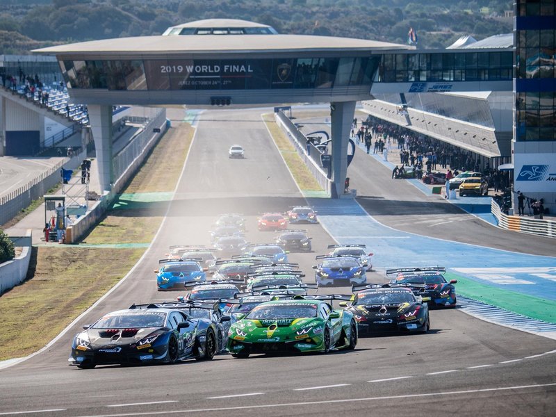 Lamborghini Huracán Super Trofeo Evo race cars in close formation on the Jerez circuit, showcasing aggressive aero kits and racing liveries