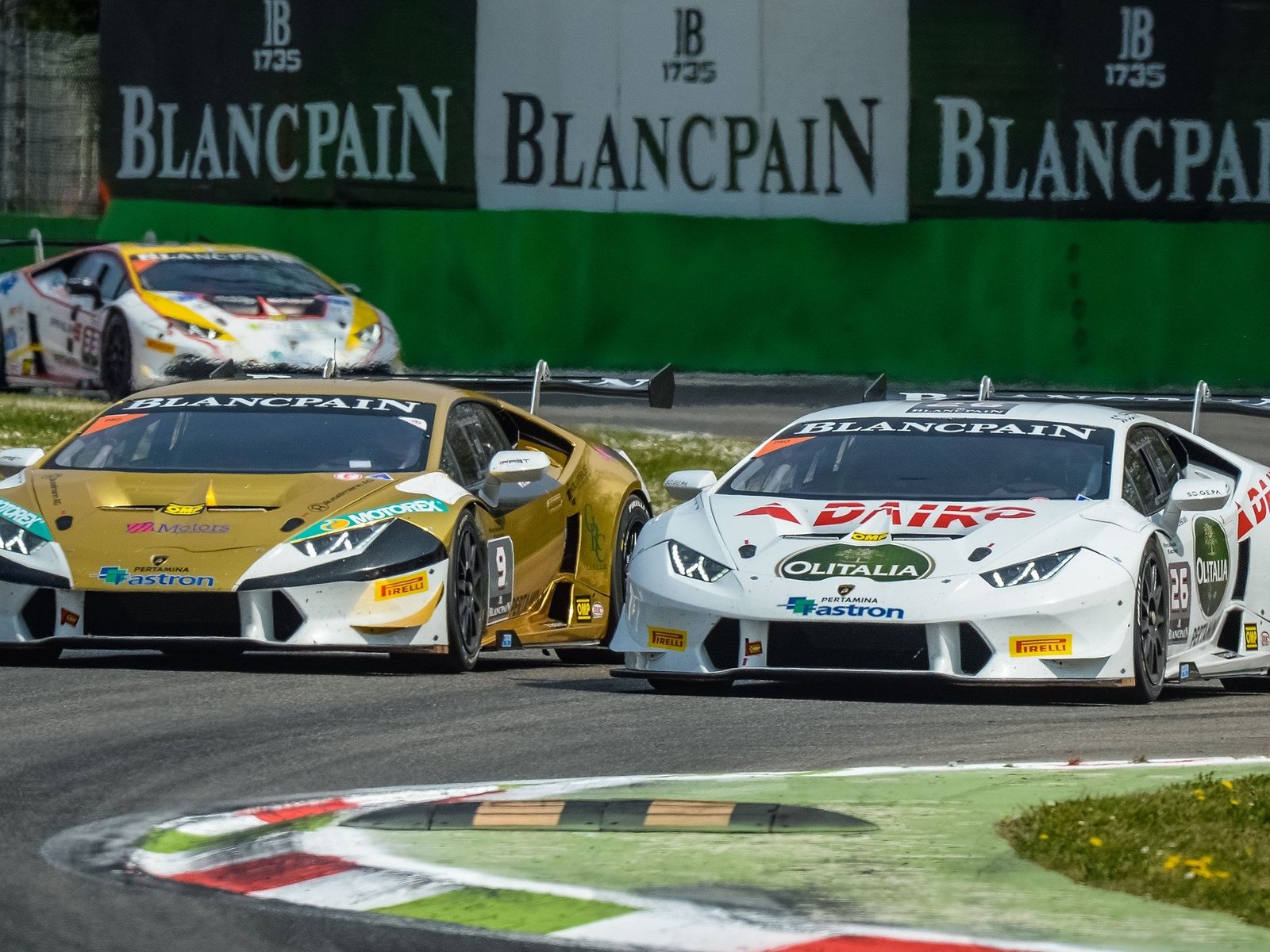 Lamborghini Huracán Super Trofeo race cars battling for position on track with Blancpain banner visible in background